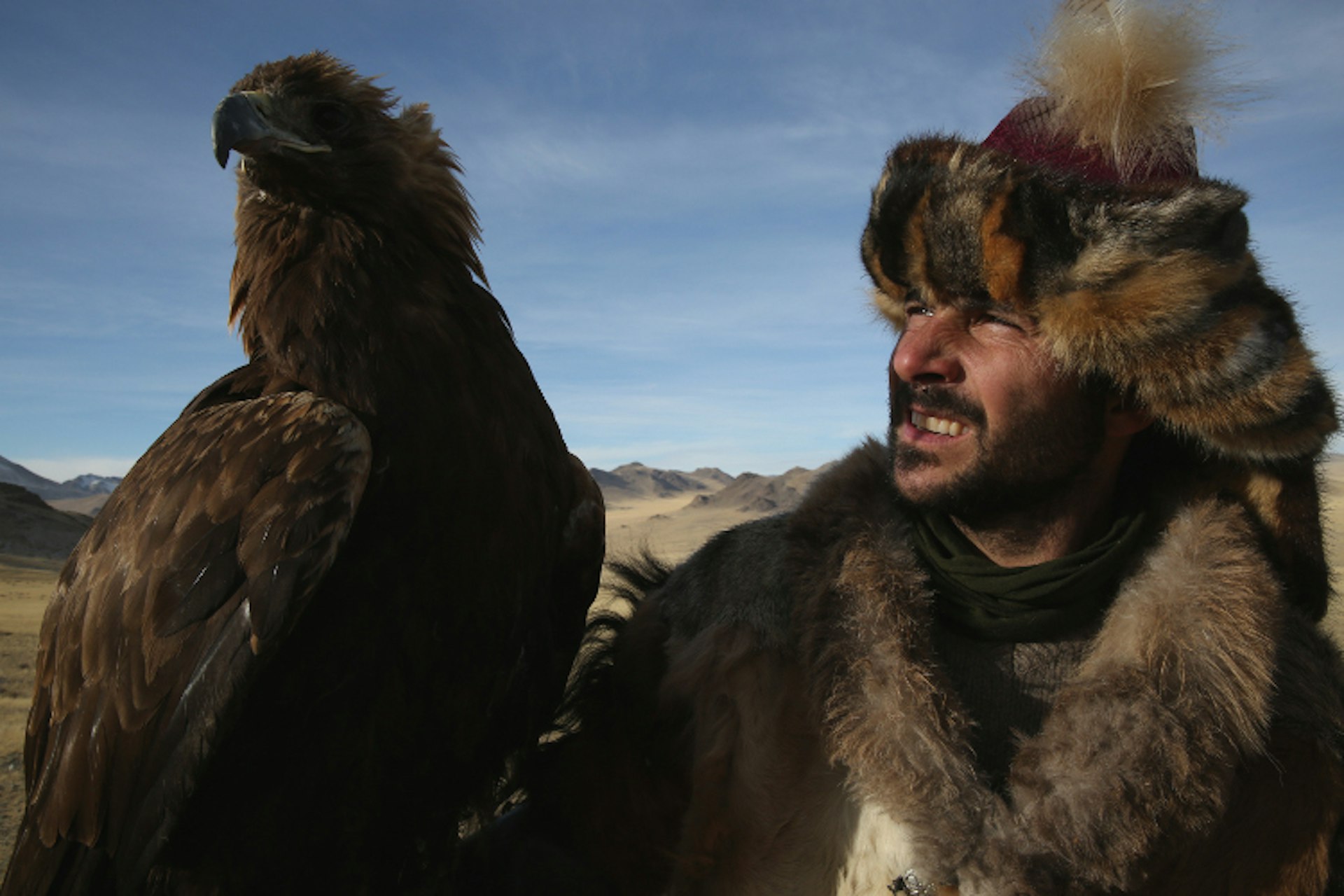Bayan Olgii, Mongolia: Hazen Audel with a golden eagle, wearing traditional hunting clothes. (Photo Credit: National Geographic Channels/Samantha Tollworthy)