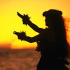 Hula dancer at sunset. Image by Ann Cecil / Getty