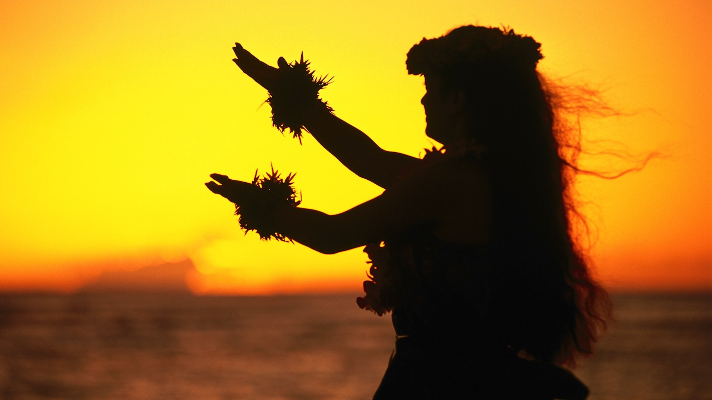 Hula dancer at sunset. Image by Ann Cecil / Getty