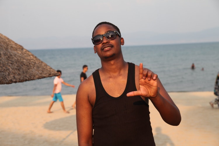Malawi MC Tay Grin relaxing before taking to the main DHLstage. Image by Nick Ray / Lonely Planet