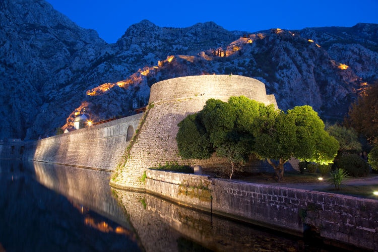 Kotor fortifications and St John’s Hill stunningly illuminated at night. Image by Martin Child / Getty Images