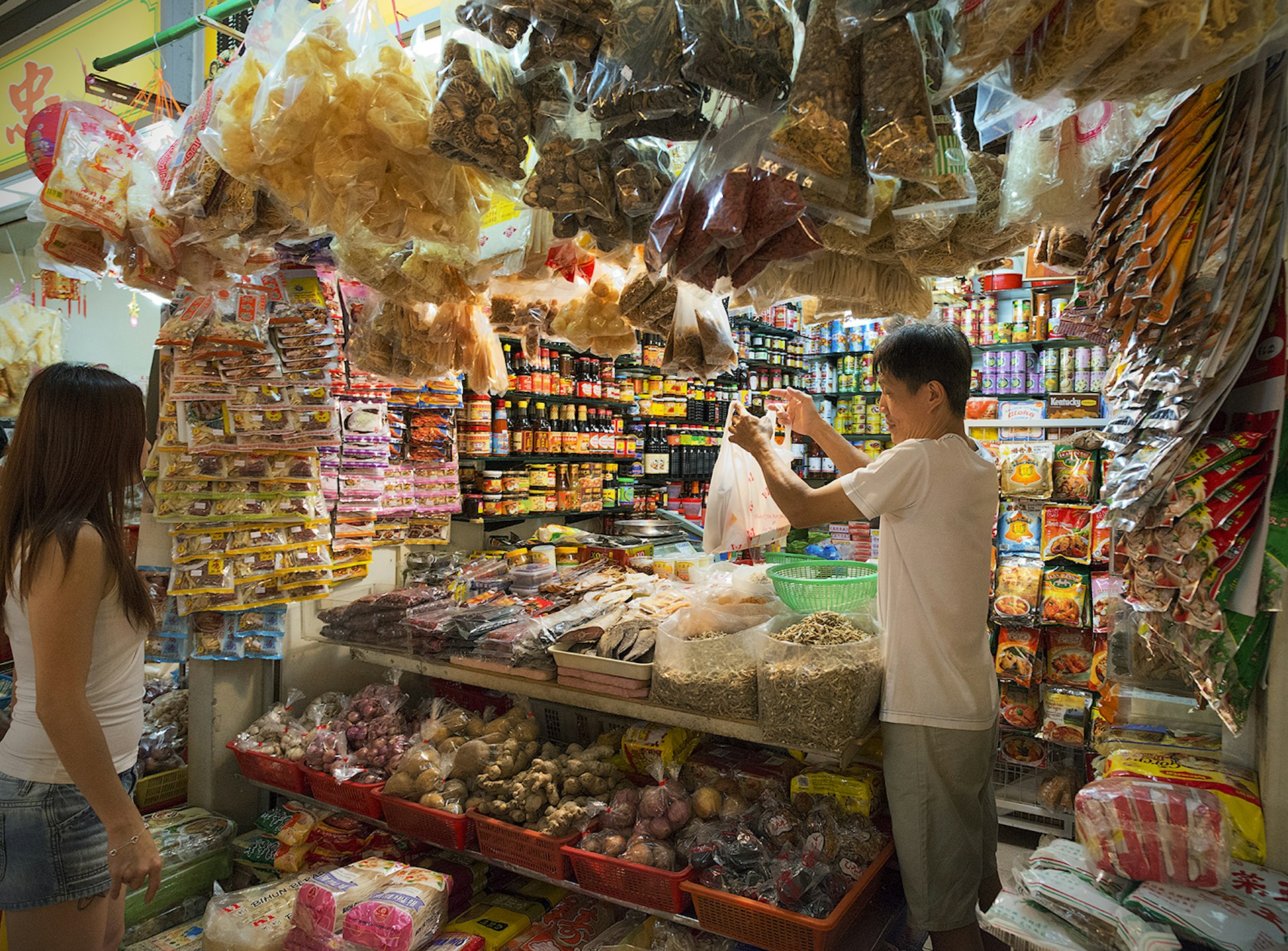 Mountains of spices, dried fish and condiments on sale in a traditional Tiong Bahru grocer's shop. Image by Andrew Too Boon Tan / Monument Mobile / Getty Images