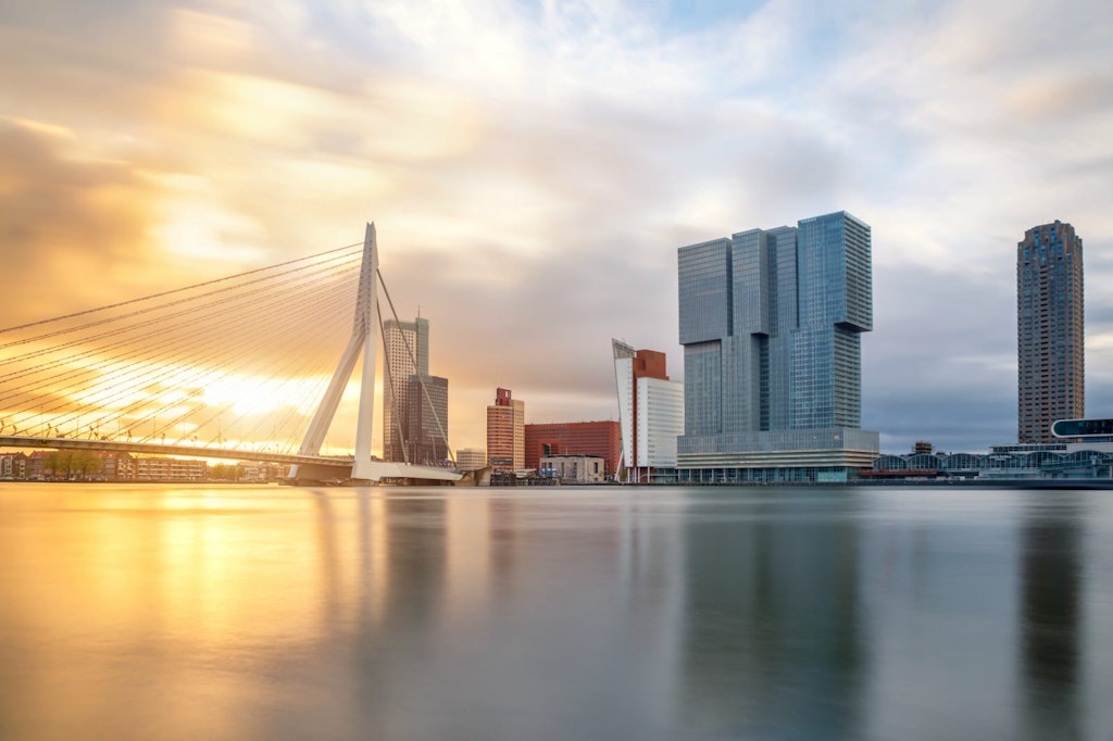The Rotterdam skyline at sunrise with the Erasmusbrug bridge over the water