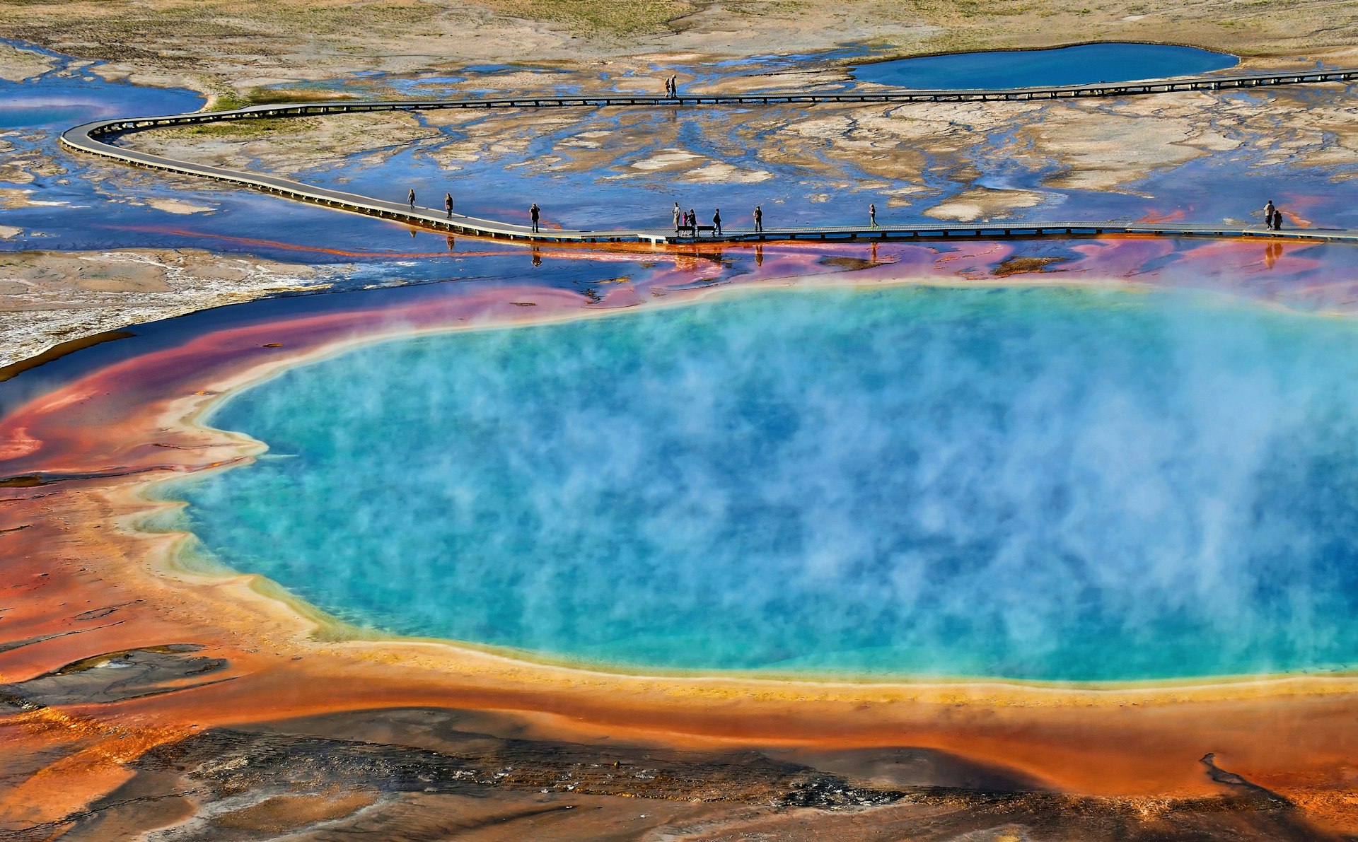 The kaleidoscopic colors of Grand Prismatic Spring in Yellowstone. Image by Noppawat Tom Charoensinphon / Getty