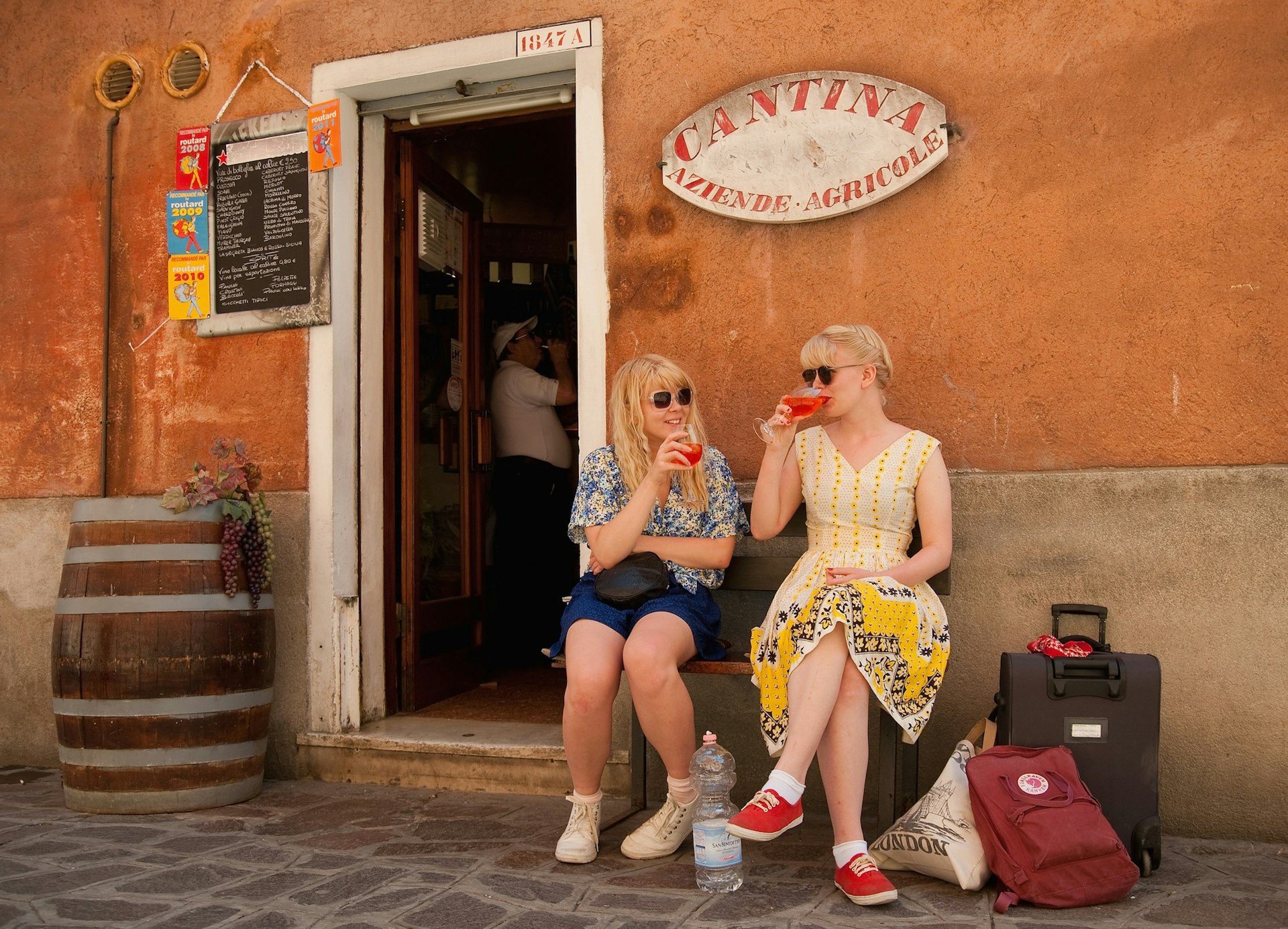 Two girls enjoy a Spritz outside a traditional bacaro. Image by Marco Secchi/Getty Images