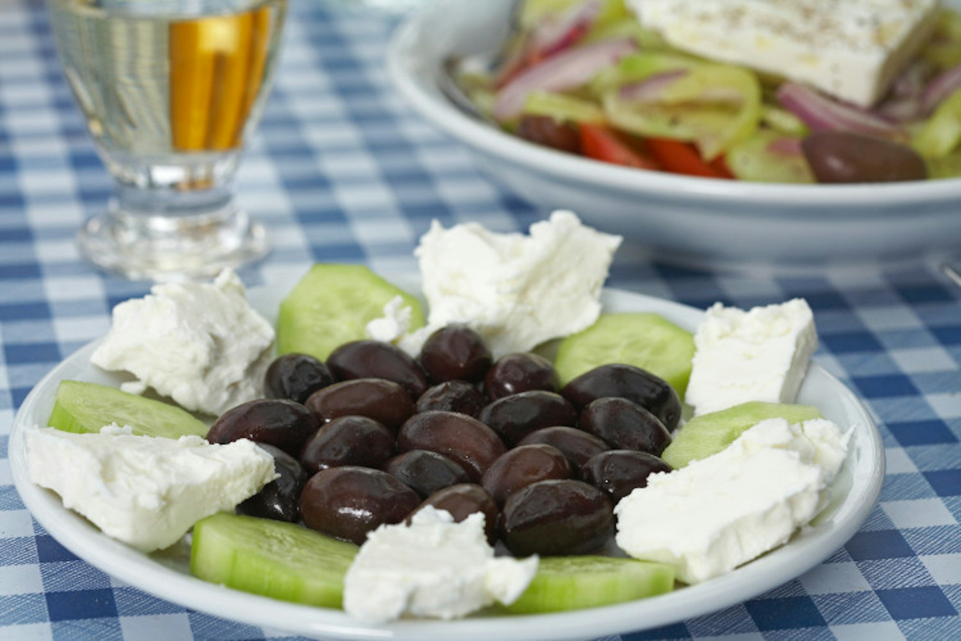 Traditional Greek salad accompanied with a glass of retsina. Image by Judith Haeusler / Cultura / Getty Images
