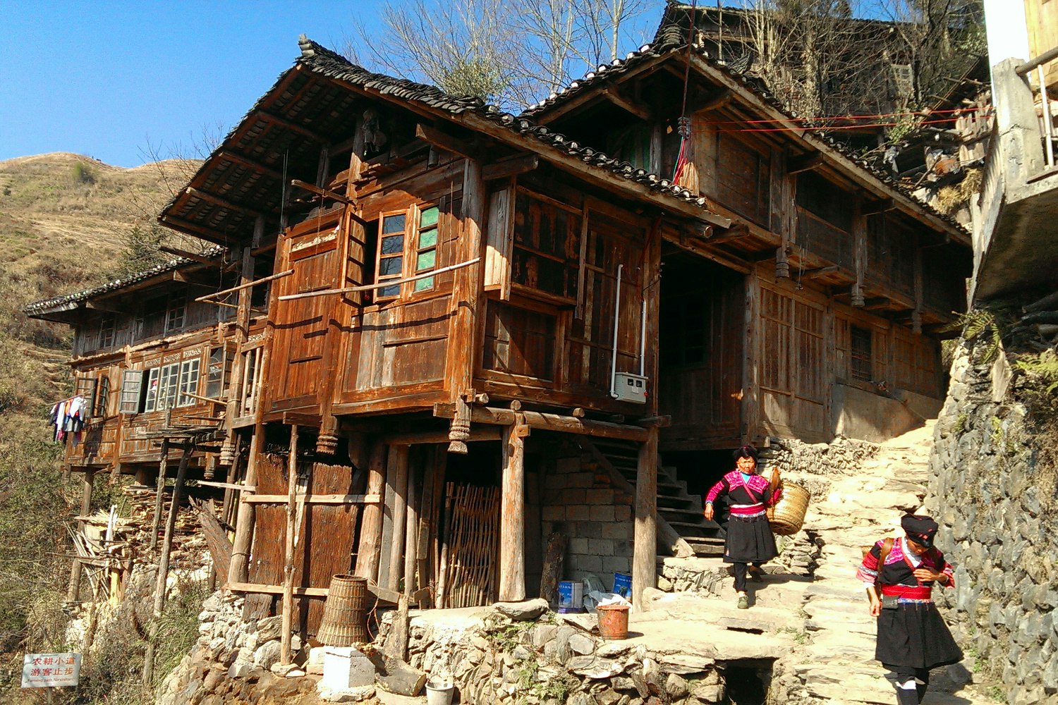 Yao minority women working outside a traditional Longji dwelling. Image by Piera Chen / Lonely Planet