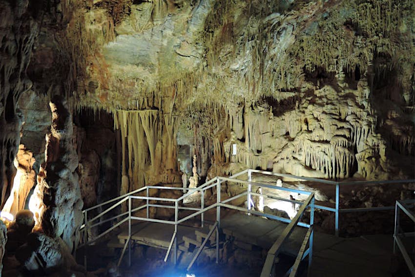 Features - Petralona-cave-Halkidiki Tourist path inside Halkidiki's Petralona Cave. Image by Carlstaffanholmer / CC BY-SA 3.0