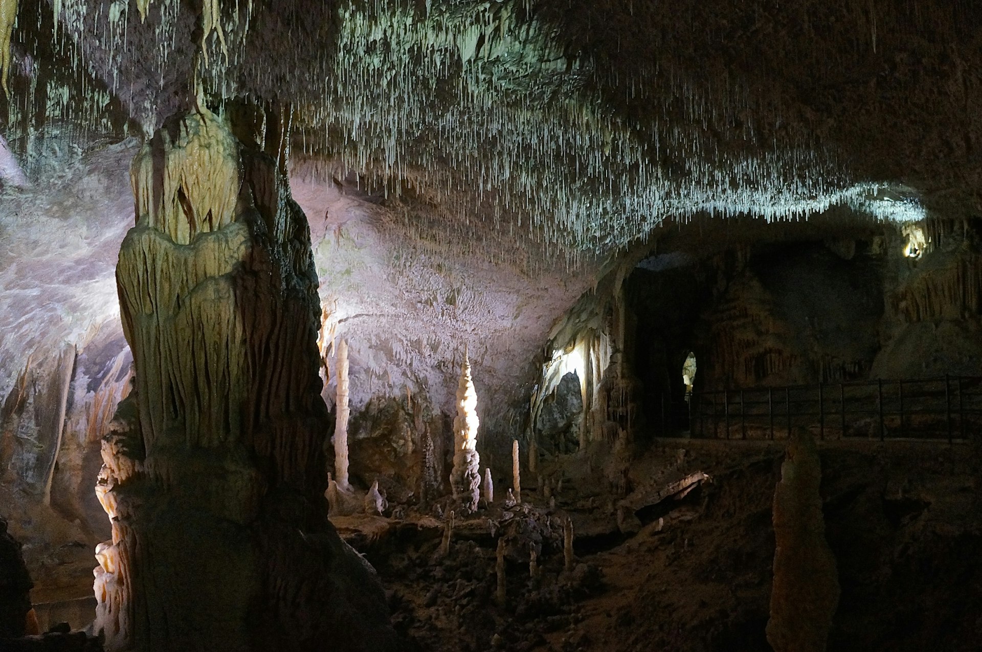 Rock formations including stalagmites and spaghetti stalactites in a cave