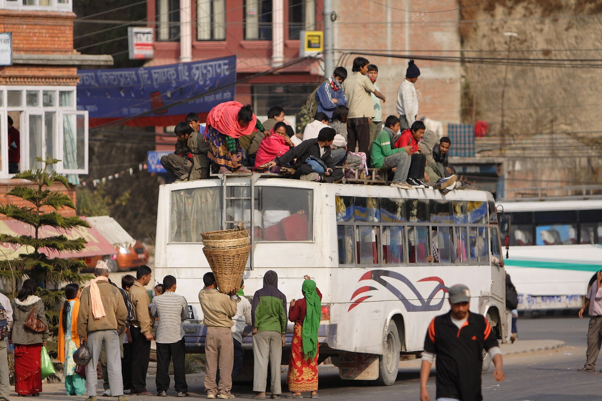 Passengers loading goods onto a local bus in Kathmandu. Image by Department of Foreign Affairs and Trade / CC by 2.0