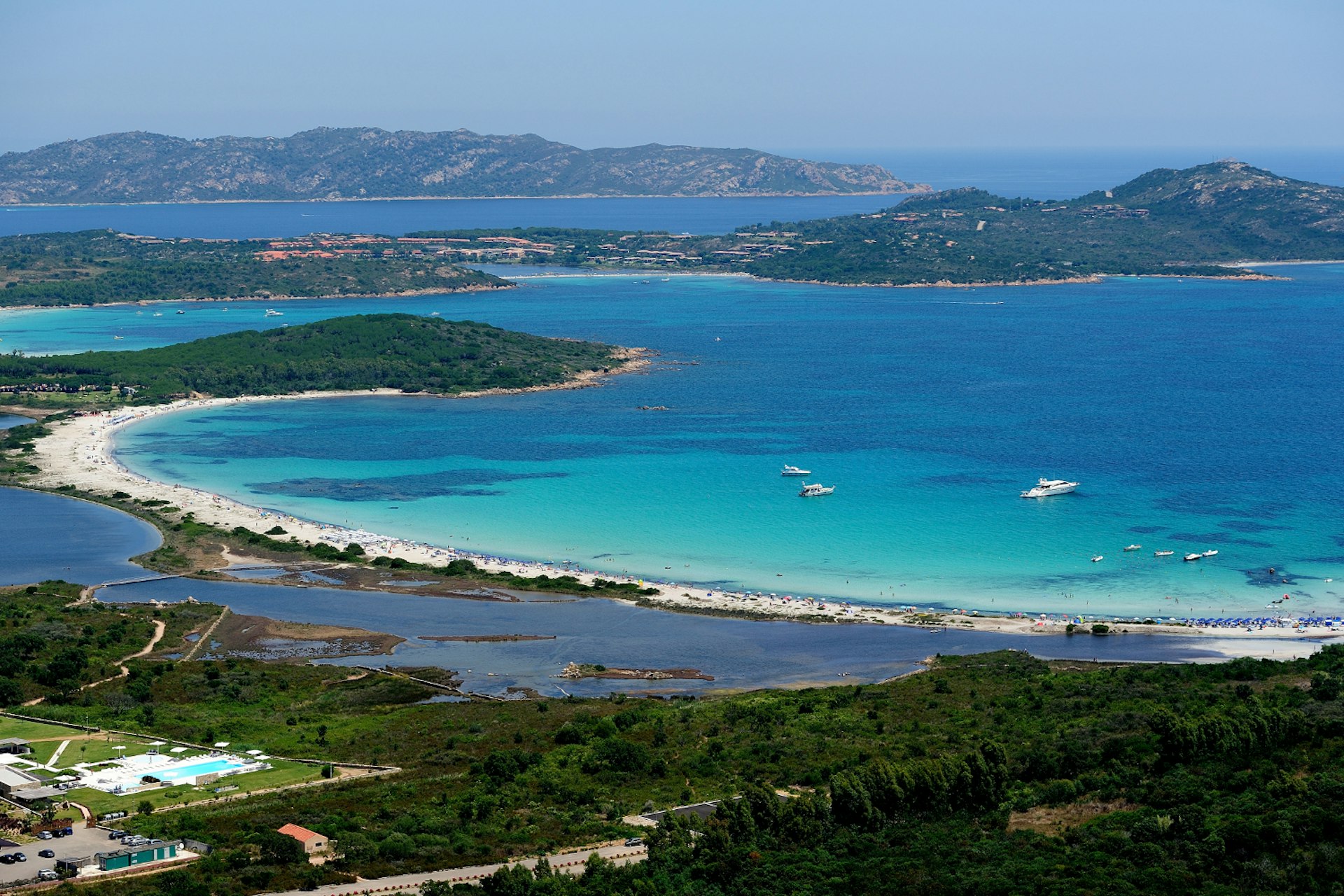 Landscape view of the expansive blue waters of Cala Brandinchi, Sardinia. 