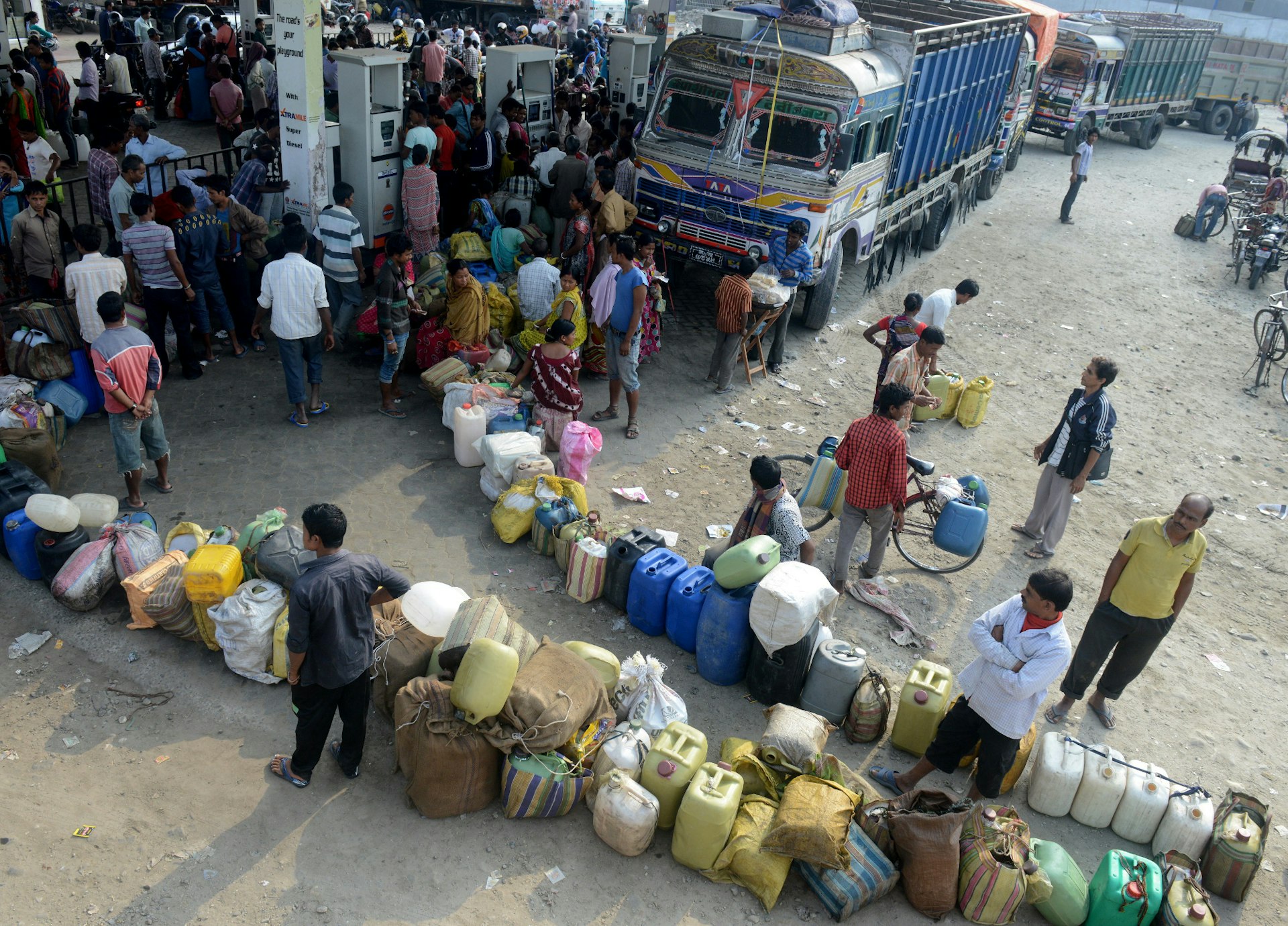 People queue for fuel at the Nepal border in Kakarbhitta. Image by DIPTENDU DUTTA / Stringer / Getty Images