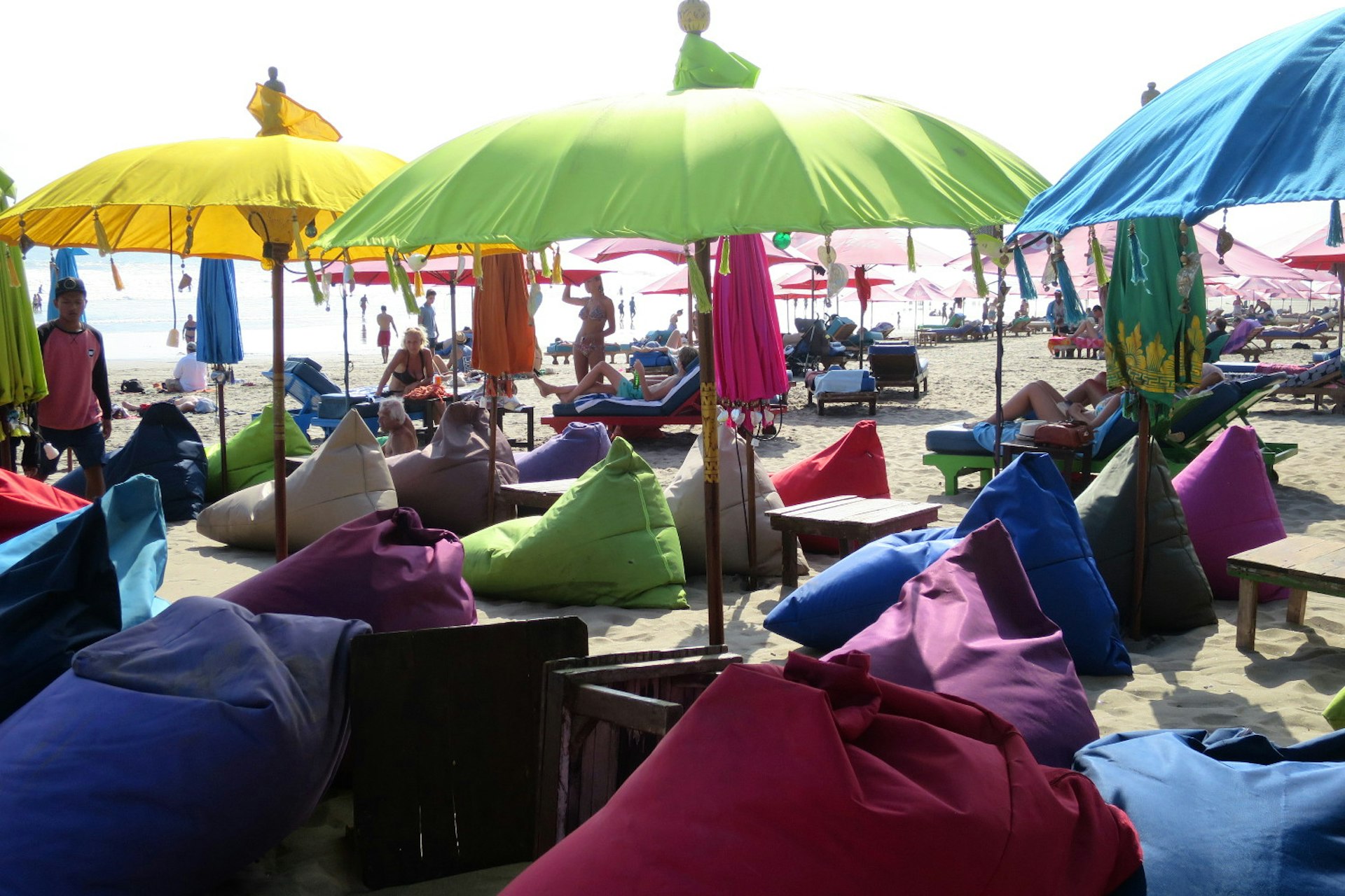 Colourful beanbag seats dot the sand in front of La Plancha bar in Bali each evening