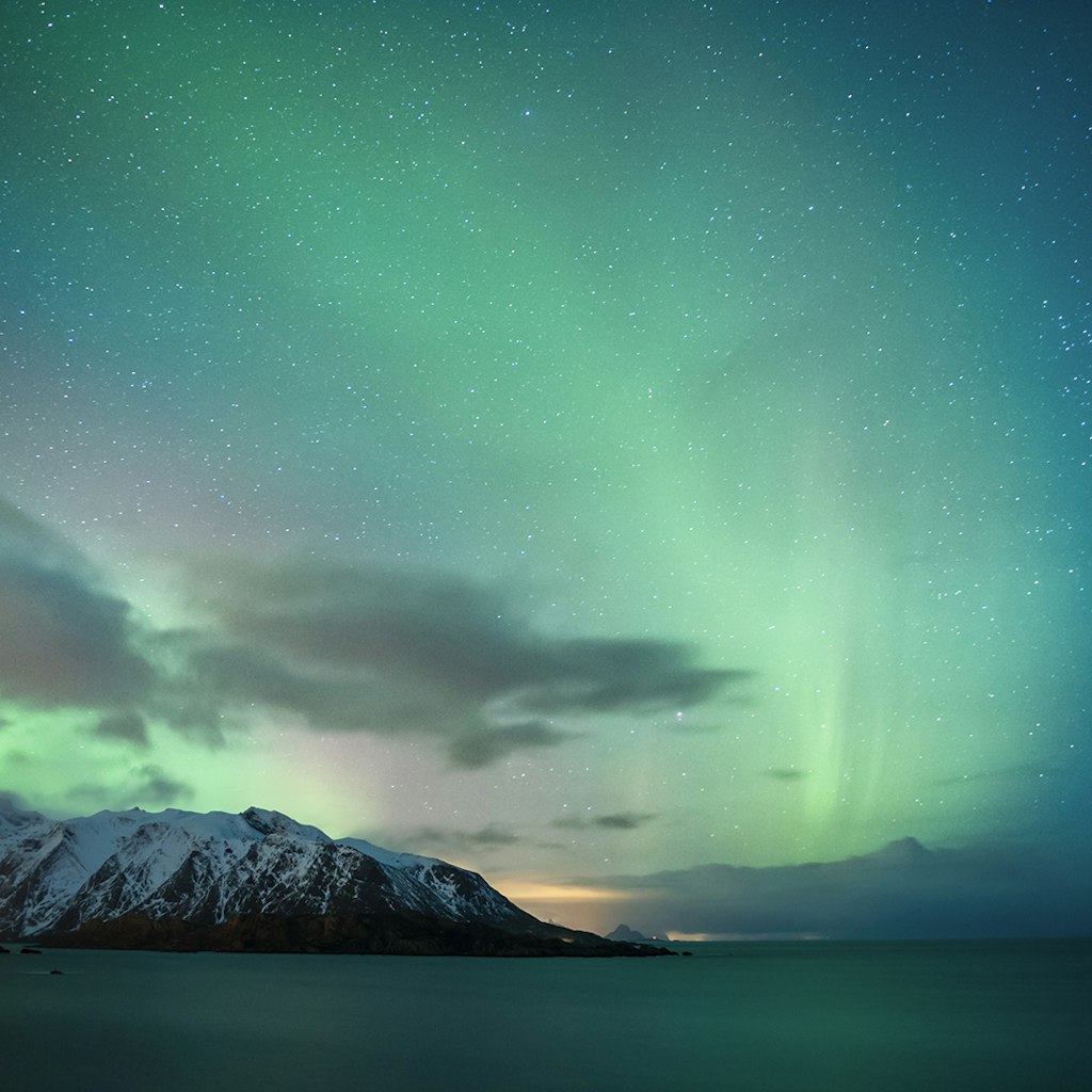 The northern lights, visible on clear nights for many of the winter months, swish across the sky near Reine.