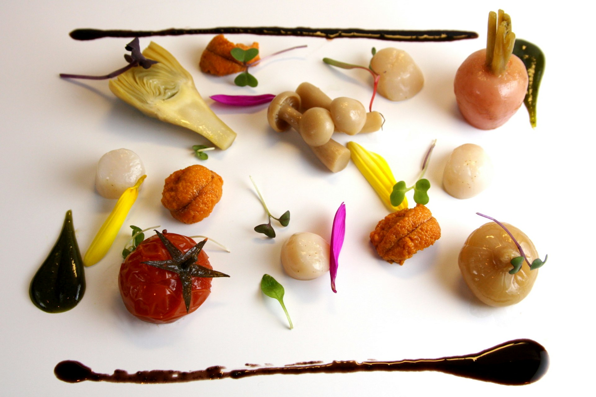 Food as art: a plate of bay sea scallop, sea urchin, preserved vegetables, and black olive oil from the Tasting Counter.