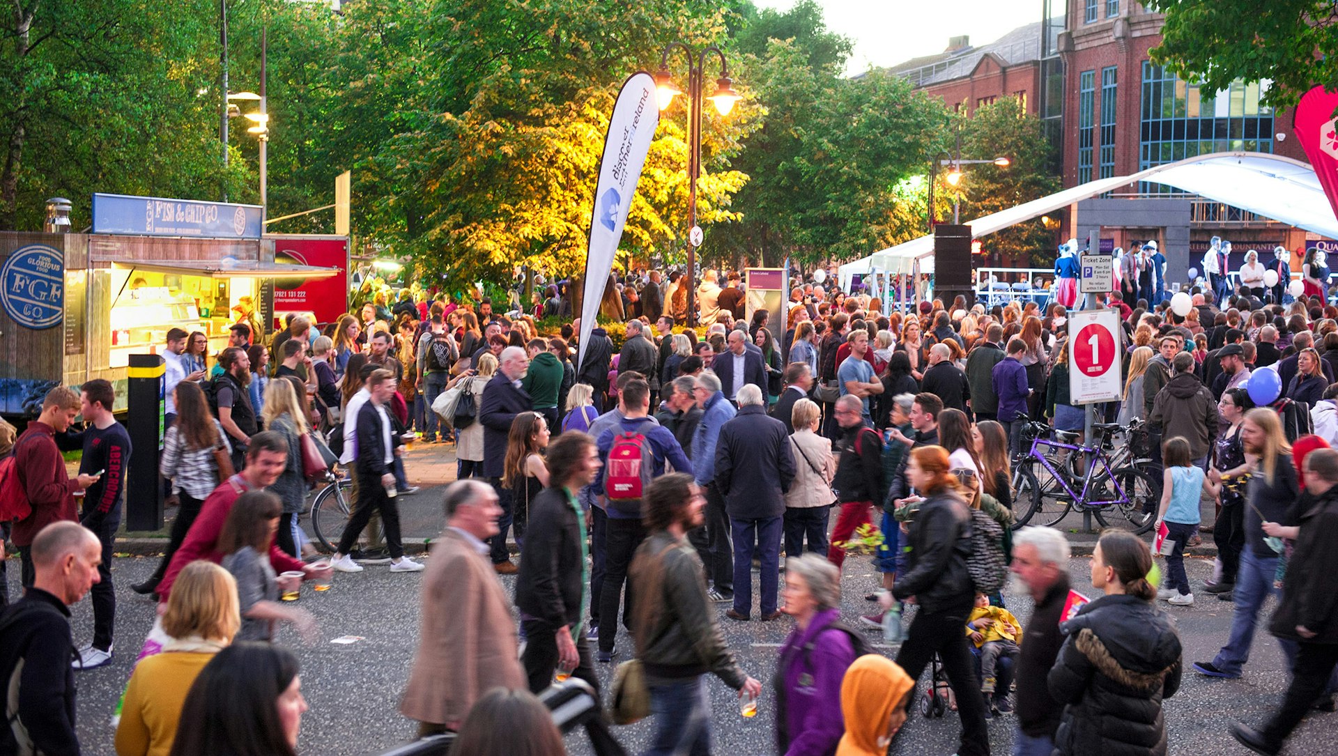 A crowd of over 60,000 revelers attends the Cathedral Quarter Arts Festival. Image by David in Lisburn / CC BY 2.0