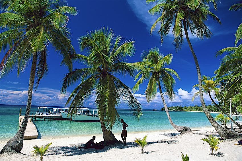 Features - GettyImages-140538975_full_cs The white sands and turquoise waters of Tabyana Beach, on Roatan © Konrad Wothe / Getty Images