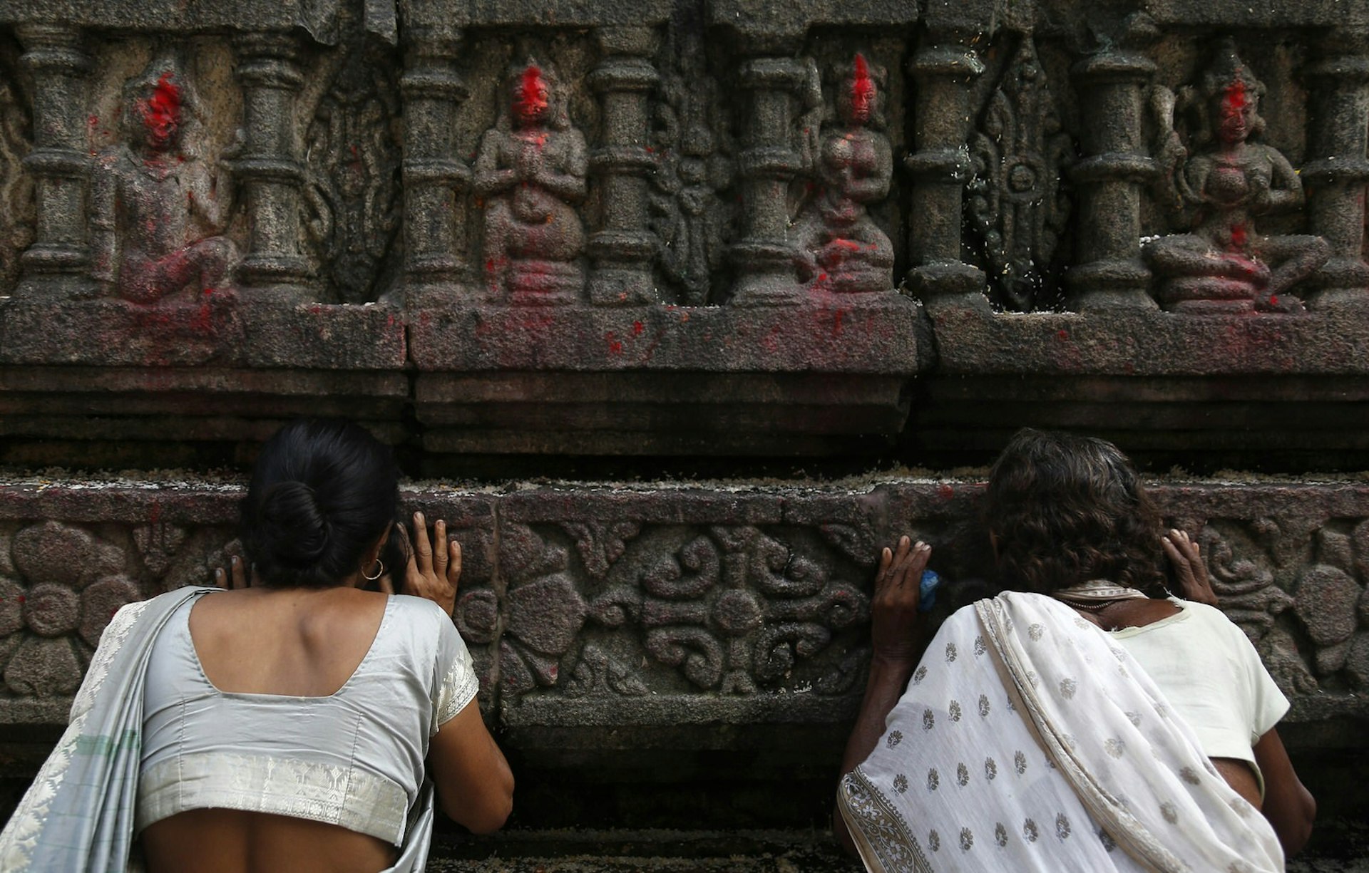 Indian women perform rituals during the Ambubachi festival at Kamakhya temple in Guwahati on June 24, 2014. Thousands of devotees from all over India gather on occasion of Ambubachi Mela, which is celebrated to mark the menstruation period of the presiding goddess of the temple, Devi Kamakhya, the Mother Shakti and during which occasion the sanctorum of the shrine remains closed to worshippers. AFP PHOTO/ ANUWAR HAZARIKA (Photo credit should read ANUWAR HAZARIKA/AFP/Getty Images)