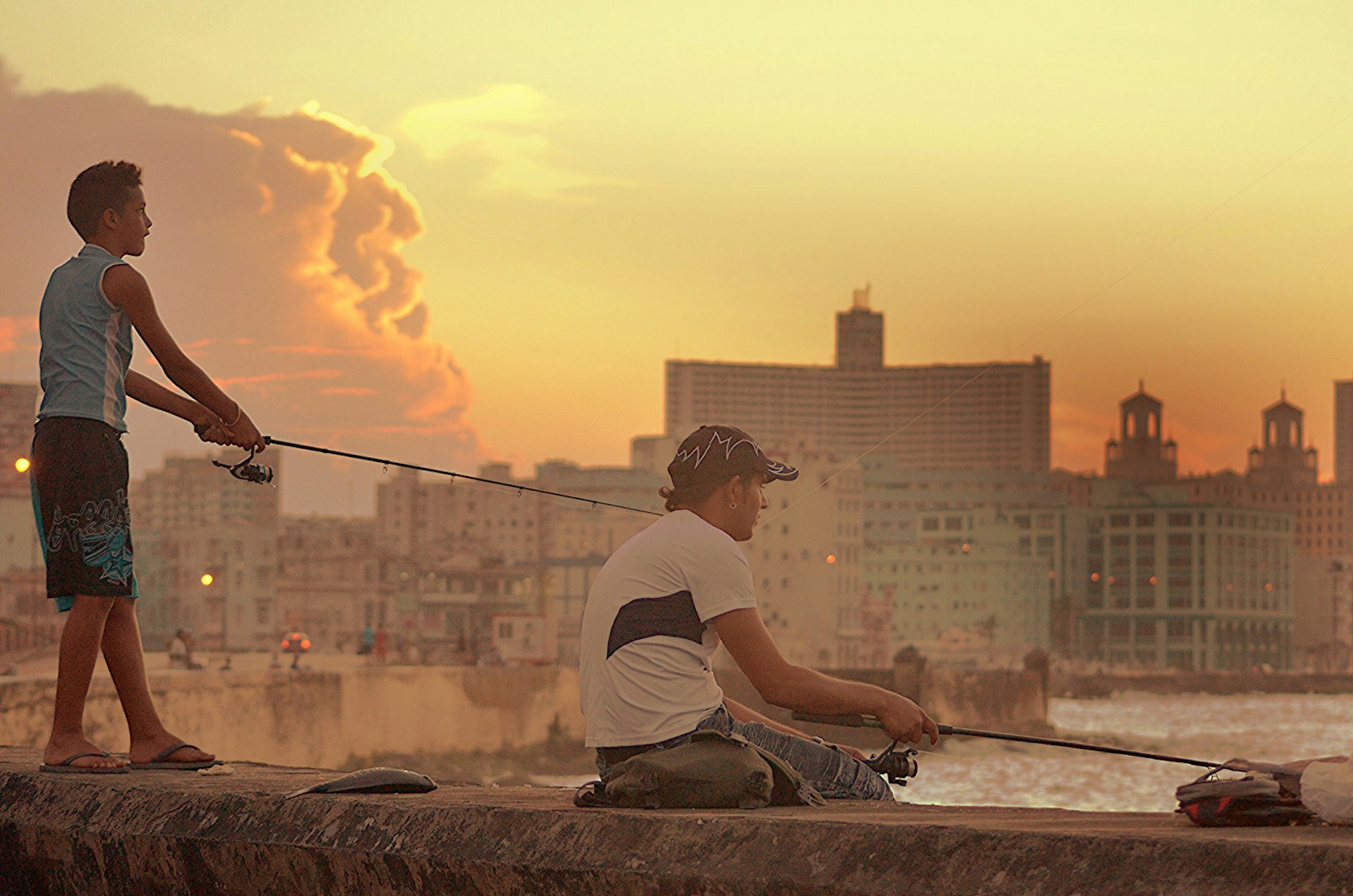 Two men fish off of the malecón © Sarah Morgan/Getty Images