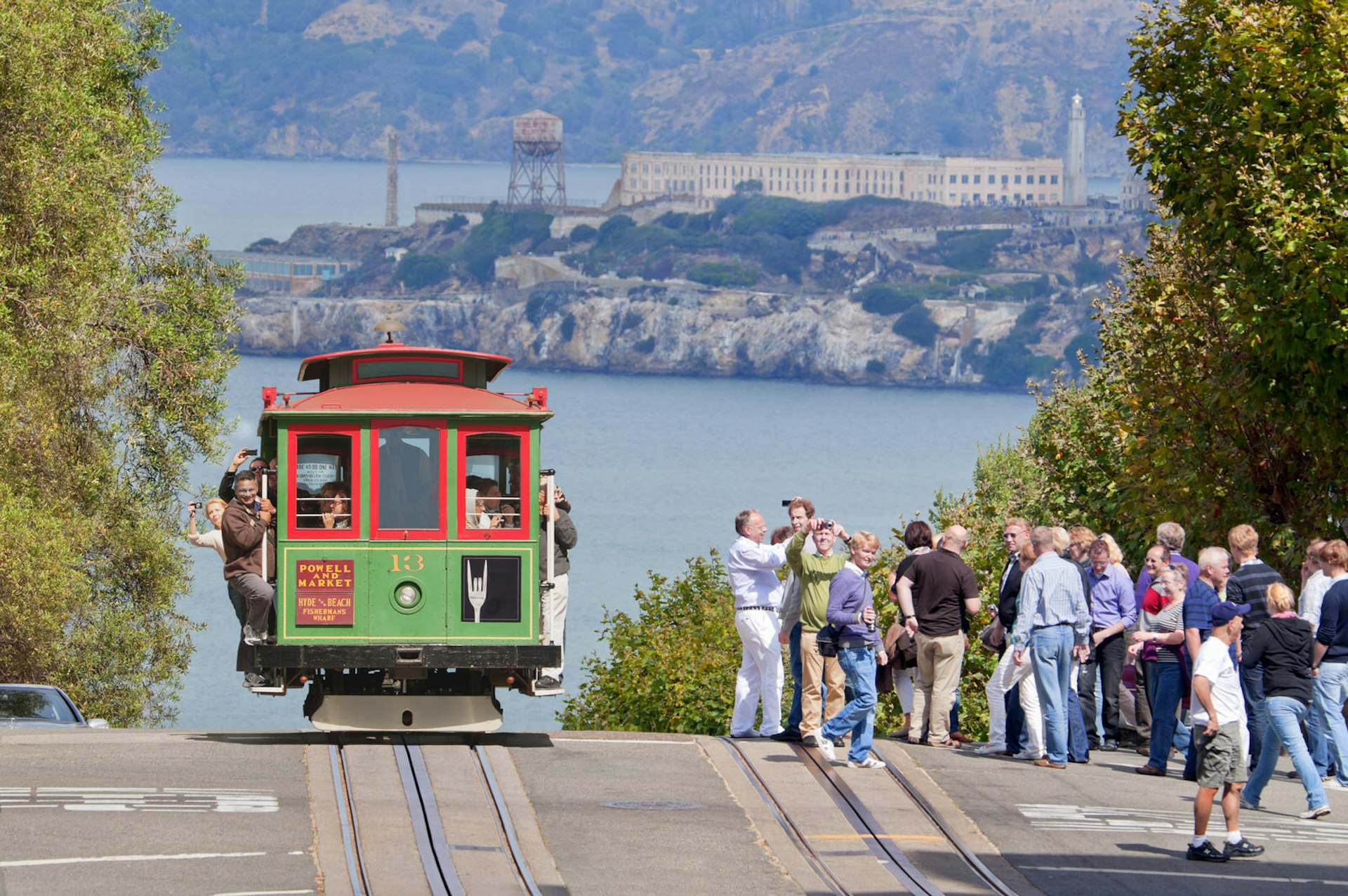 Cable car at Lombard Street with Alcatraz Island