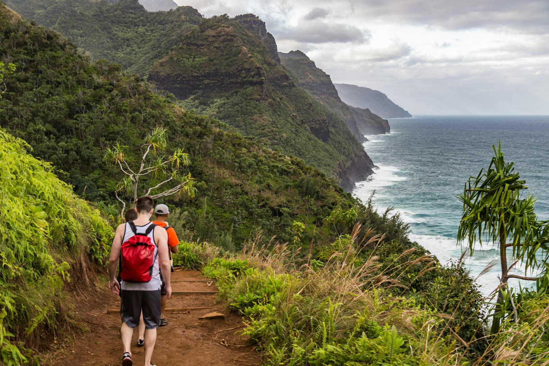 Hikers on the Kalalau Trail on the Na Pali Coast of Kauai © Alexander Howard / Lonely Planet