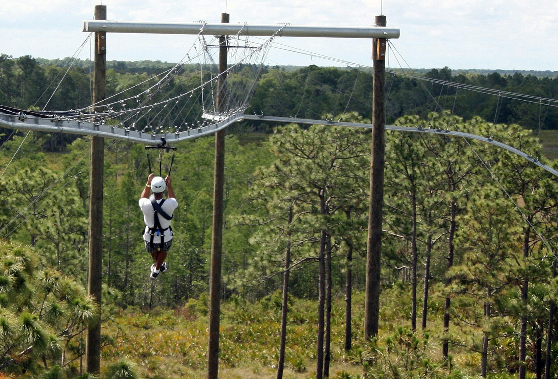 A first-time zip line rider is about to hit a curve on The Rattlesnake, which dips and twists and turns like a roller coaster, at Florida EcoSafaris at Forever Florida. (Marjie Lambert/Miami Herald/MCT via Getty Images)