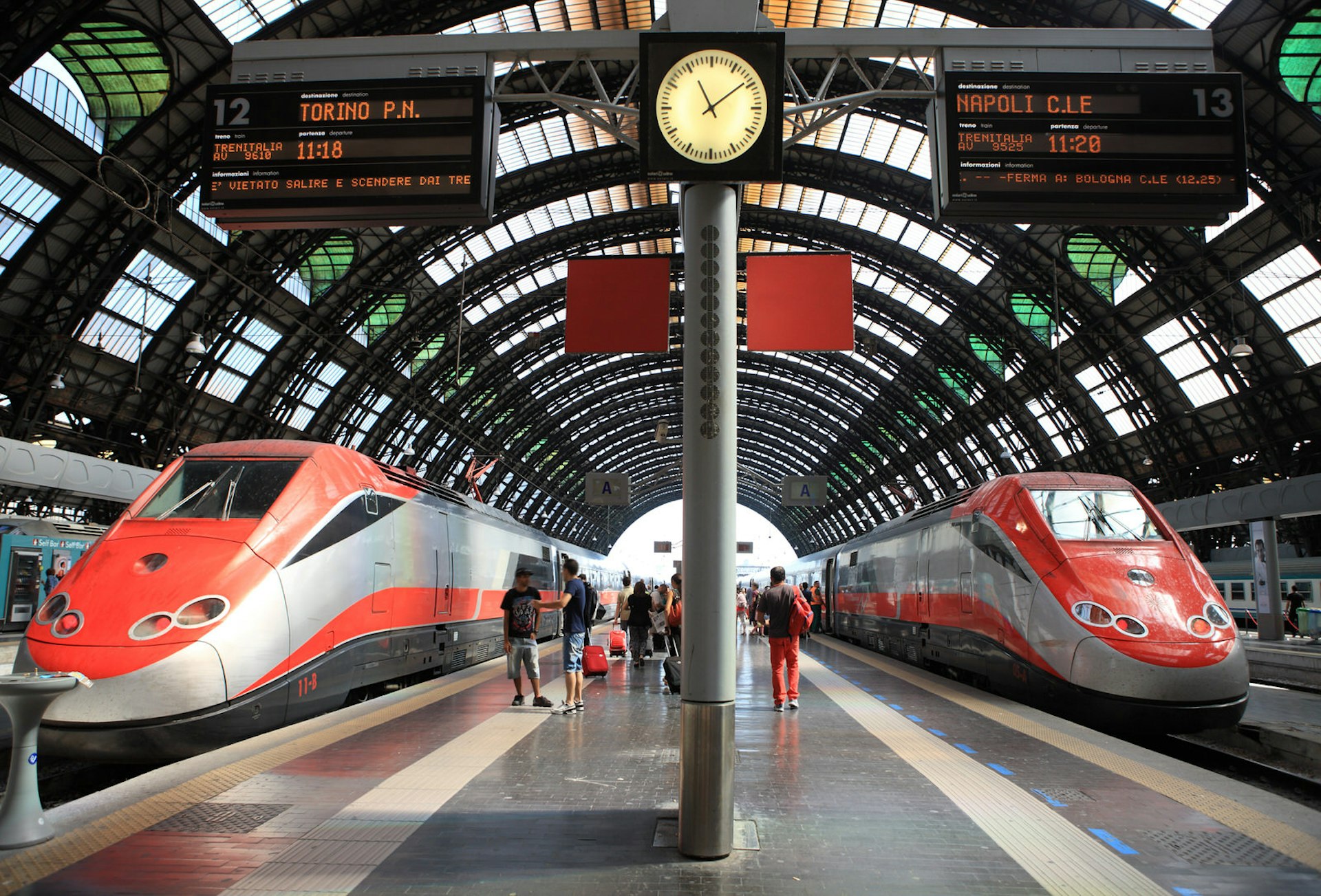 Two Frecciarossa trains await departure in Milan's beautiful Stazione Centrale
