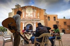 Features - Dominican Republic, Colonial zone, Group of people playing guitars outside Convent de Los Dominicos