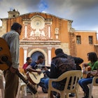 Features - Dominican Republic, Colonial zone, Group of people playing guitars outside Convent de Los Dominicos
