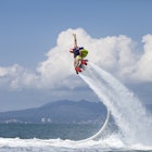 Features - Guy Airboarding Pacific Ocean, Mountains in Backgr