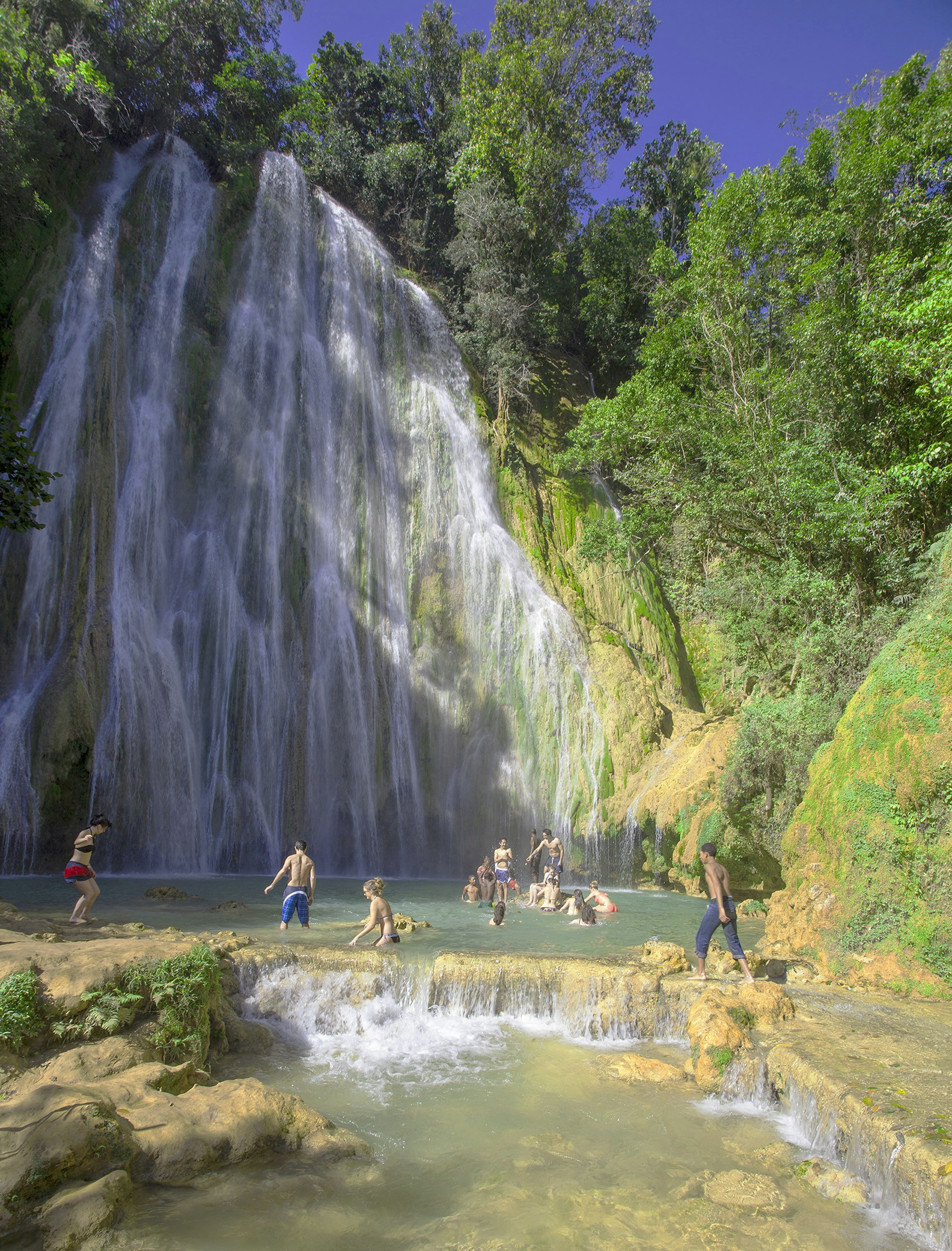 A group people play in a swimming hole near a waterfall at Cascada El Limon. The Dominican Republic has more than to offer than just beaches. 