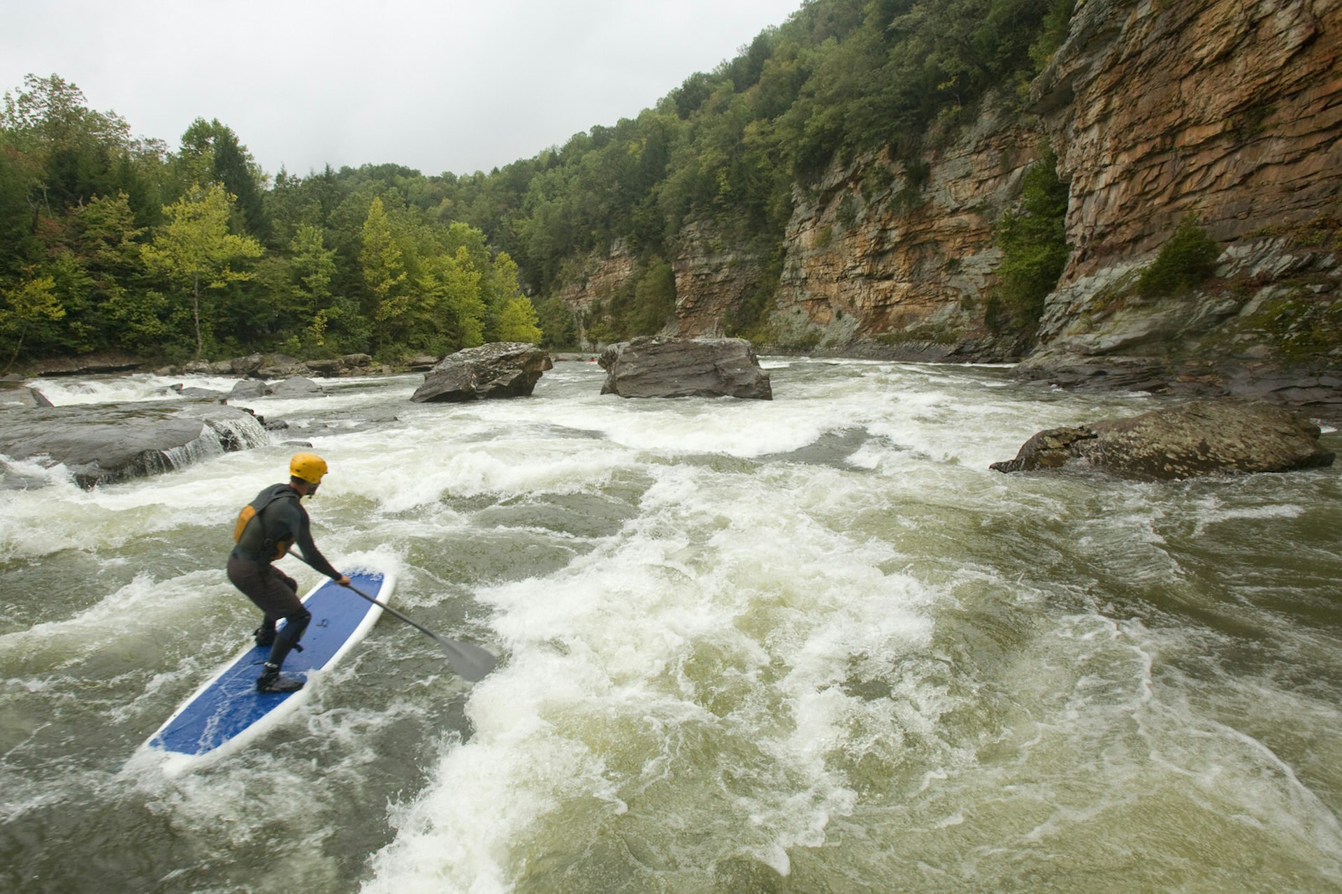 Luke Hopkins entering Canyon Doors while stand up paddleboarding the lower Gauley River near Fayetteville, West Virginia.