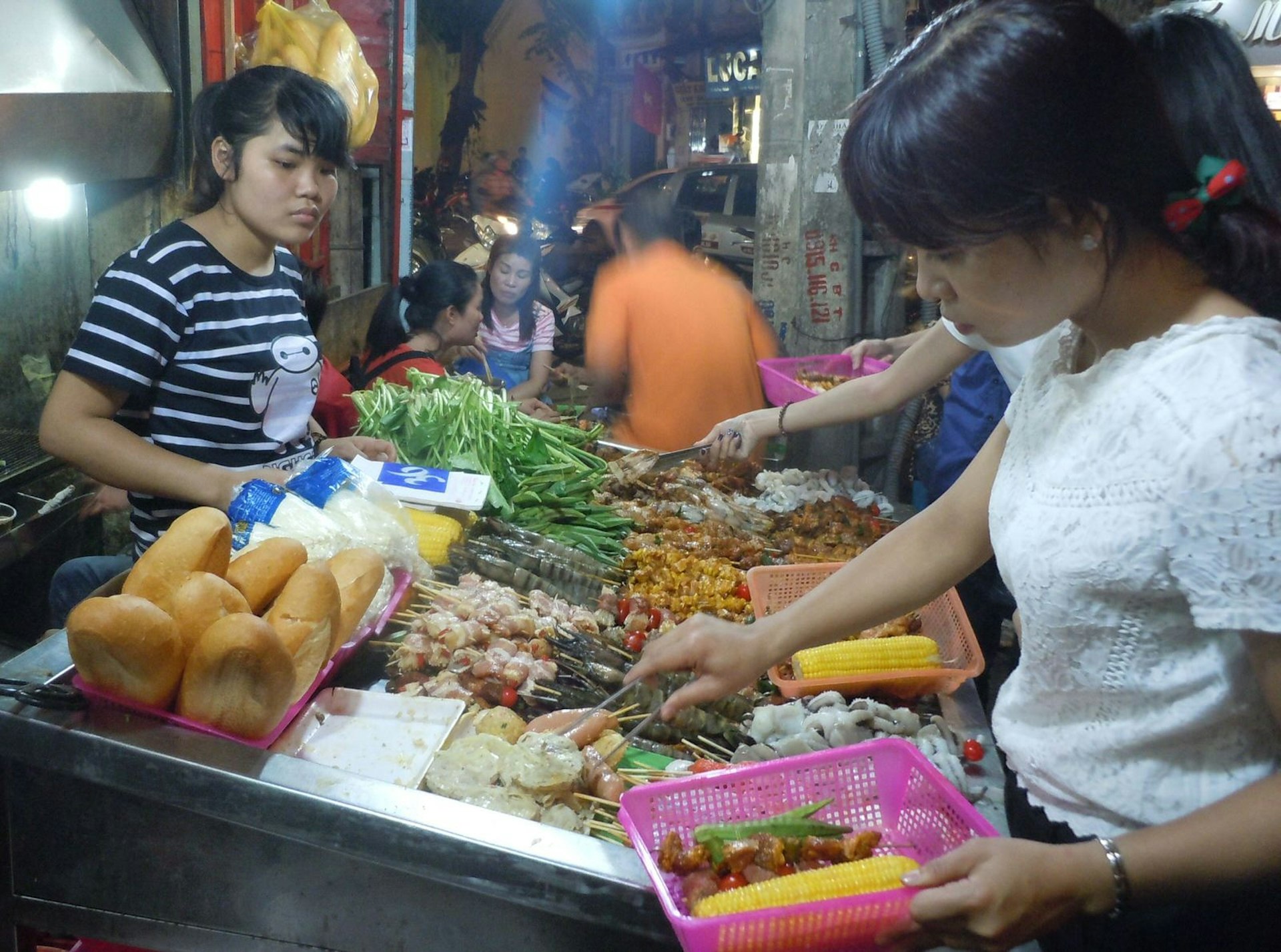 Diners selecting meat and veggies for the barbecue