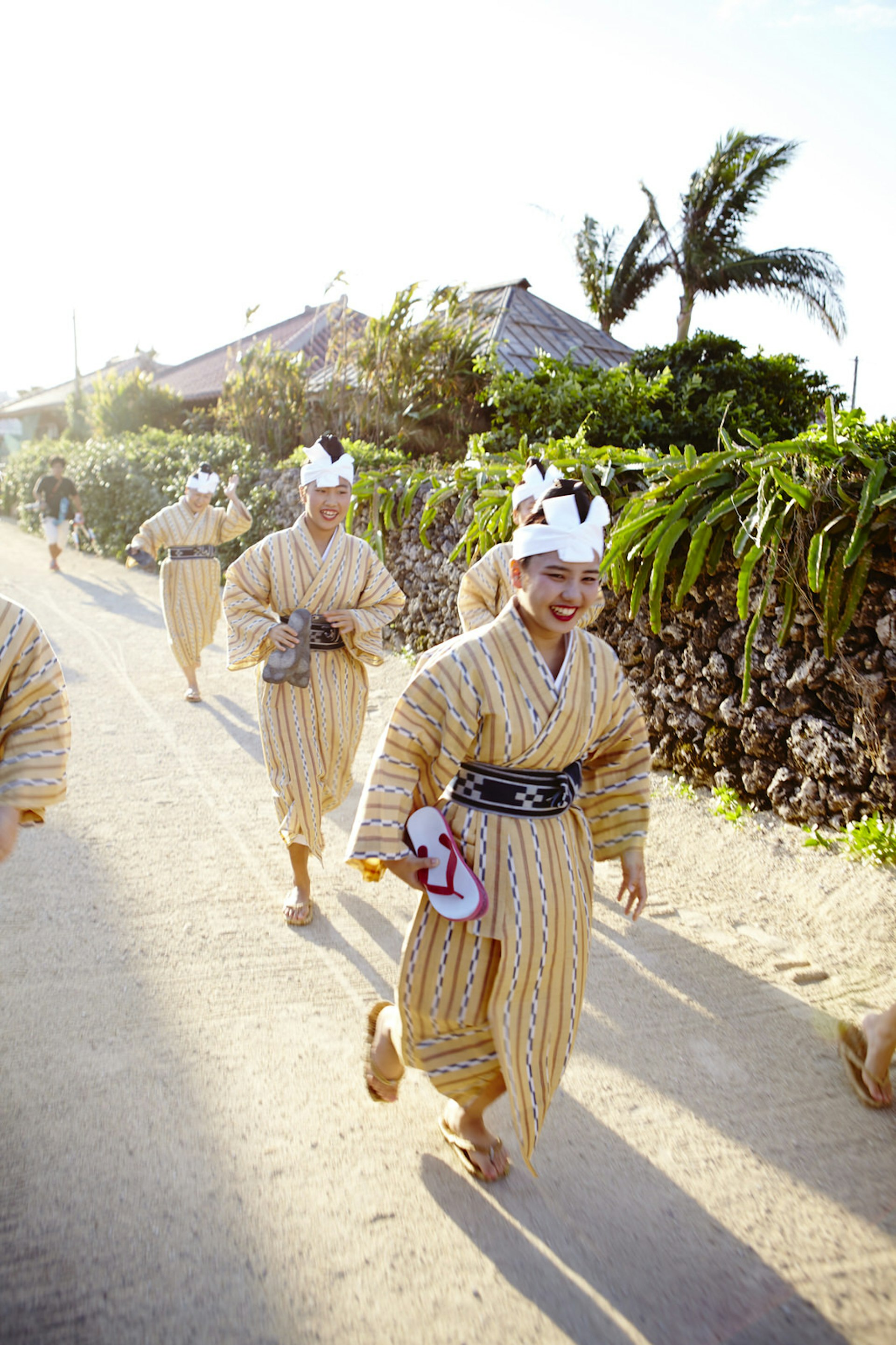Villagers walk through the streets of Taketomi, on their way to perform in Tanadui festivities © Matt Munro / Lonely Planet