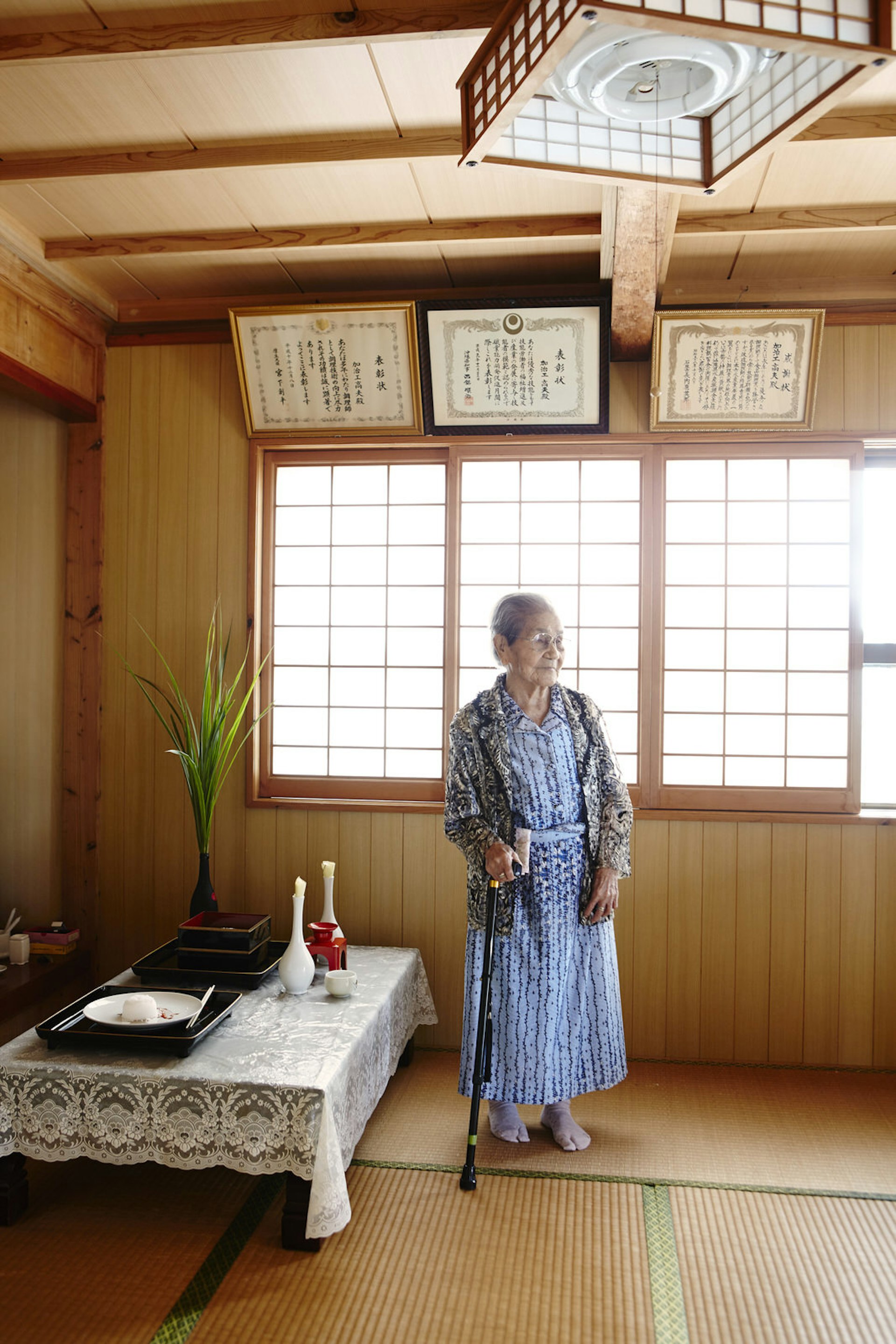 Mrs Toyo Kajigu in her house on the island of Taketomi; tatami mat floors often denote the 'best room' in a Japanese house © Matt Munro / Lonely Planet