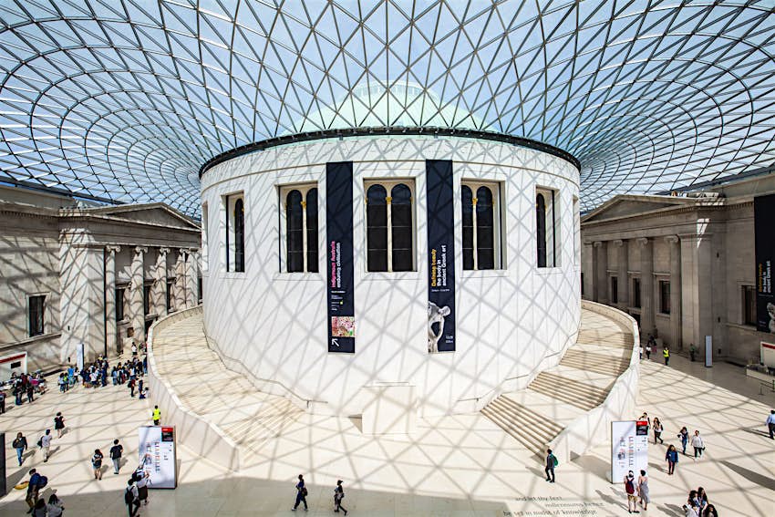 The central hall of the British Museum in London is a large round white space flooded with light from the glass ceiling