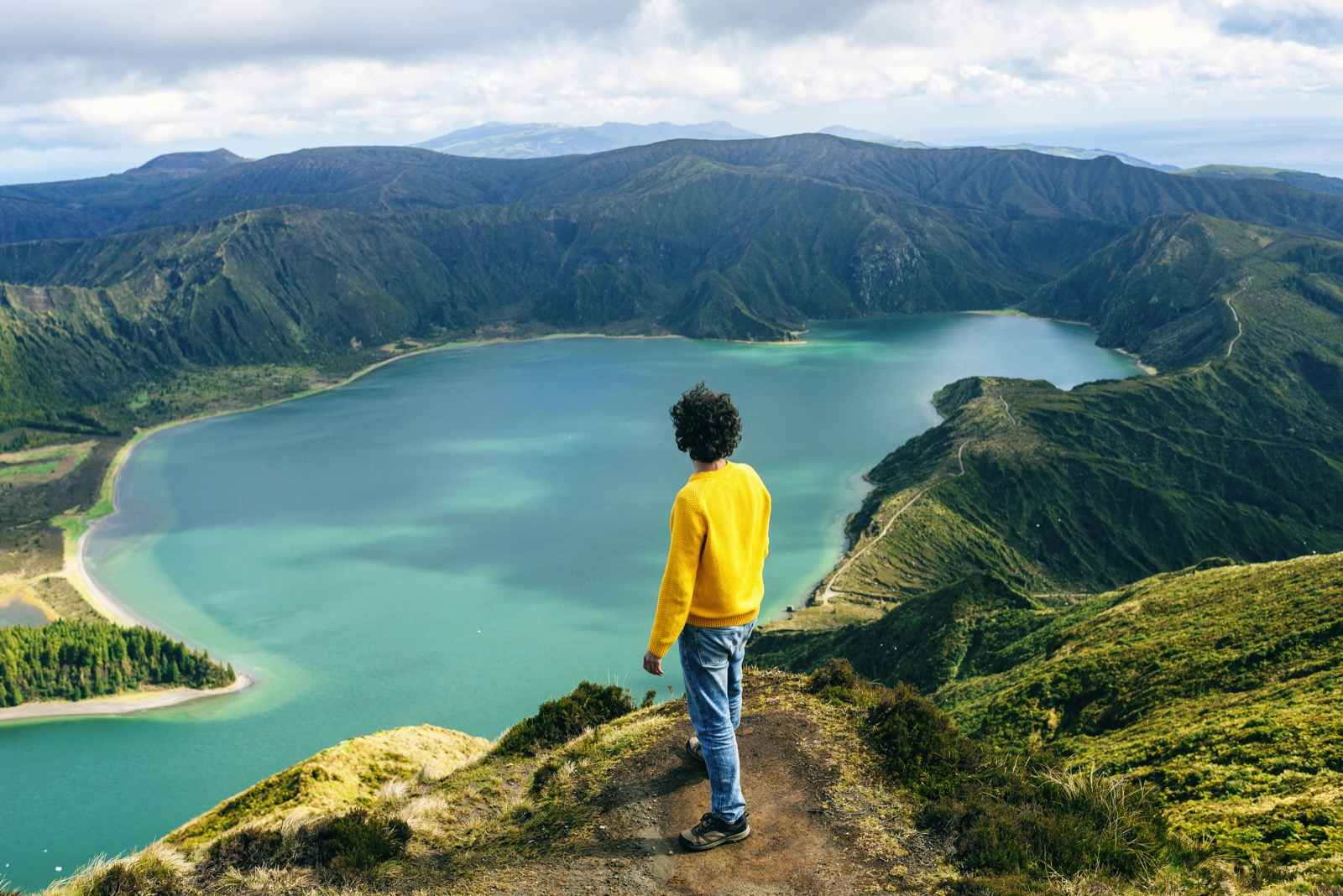 Azores Islands, San Miguel, Man looking at the Lake of Fire, seen from behind.