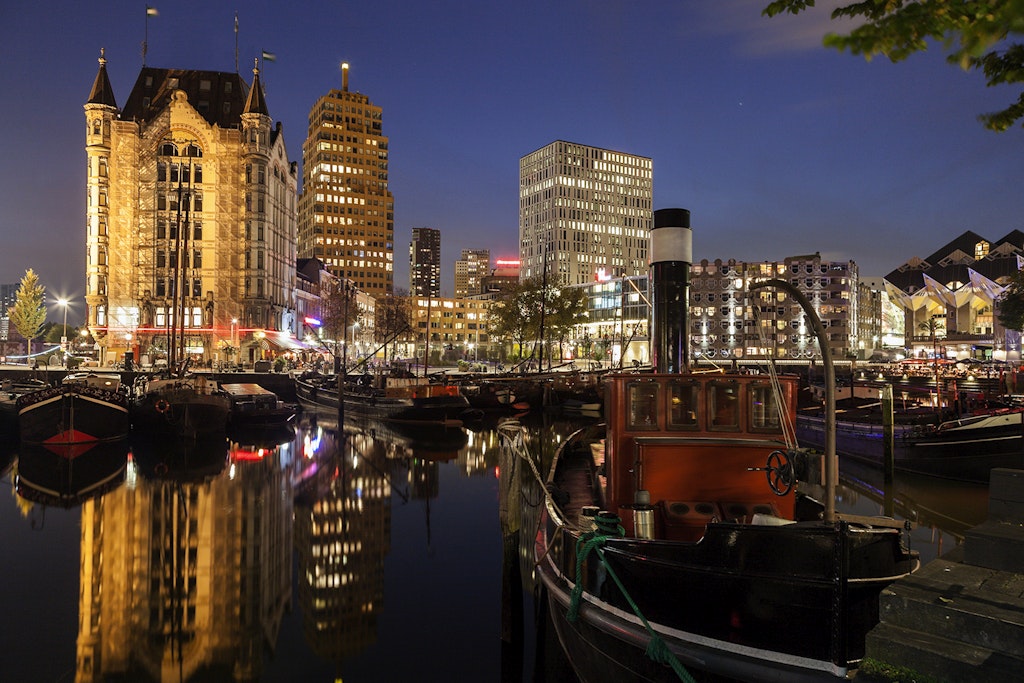 Features - Netherlands, South Holland, Rotterdam. Old Harbor skyline illuminated at dawn