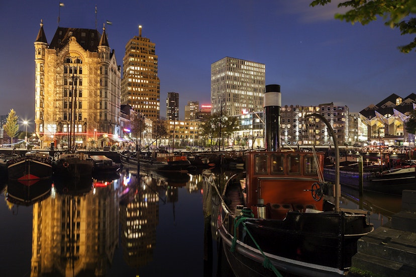 Features - Netherlands, South Holland, Rotterdam. Old Harbor skyline illuminated at dawn