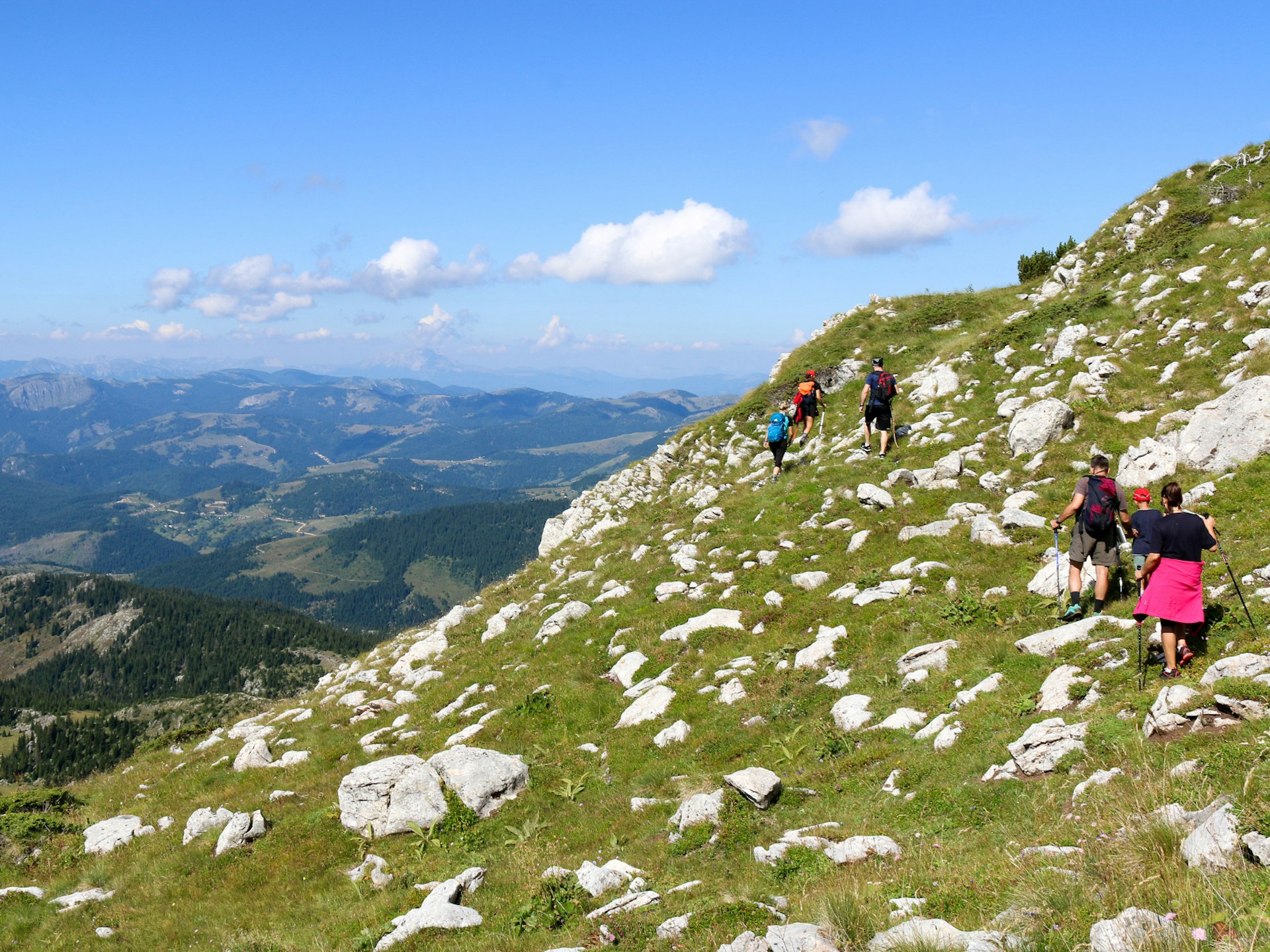 A group of hikers exploring western Kosovo's mountain slopes © Bridget Nurre Jennions / Lonely Planet