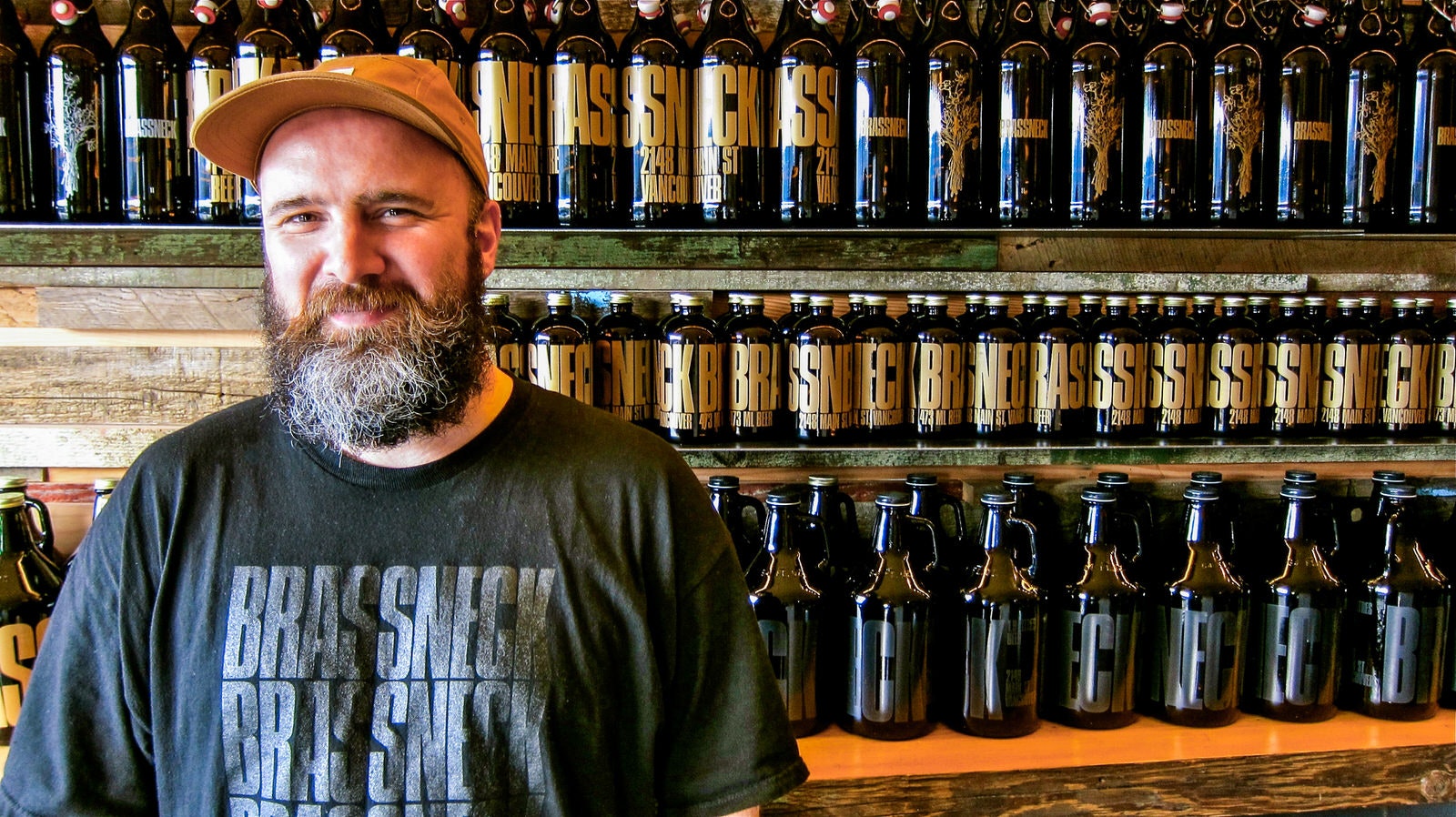 Co-owner Nigel Springthorpe stands in front of growlers at Brassneck Brewery © John Lee / Lonely Planet