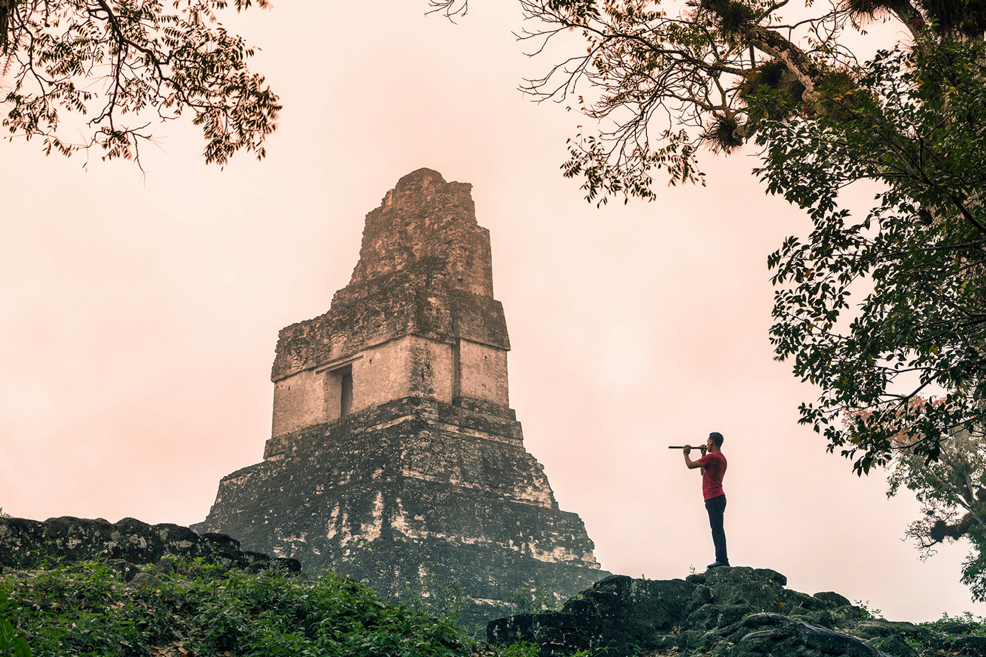 A local man plays a flute at Tikal National Park in El Petén © Matteo Colombo / Getty Images