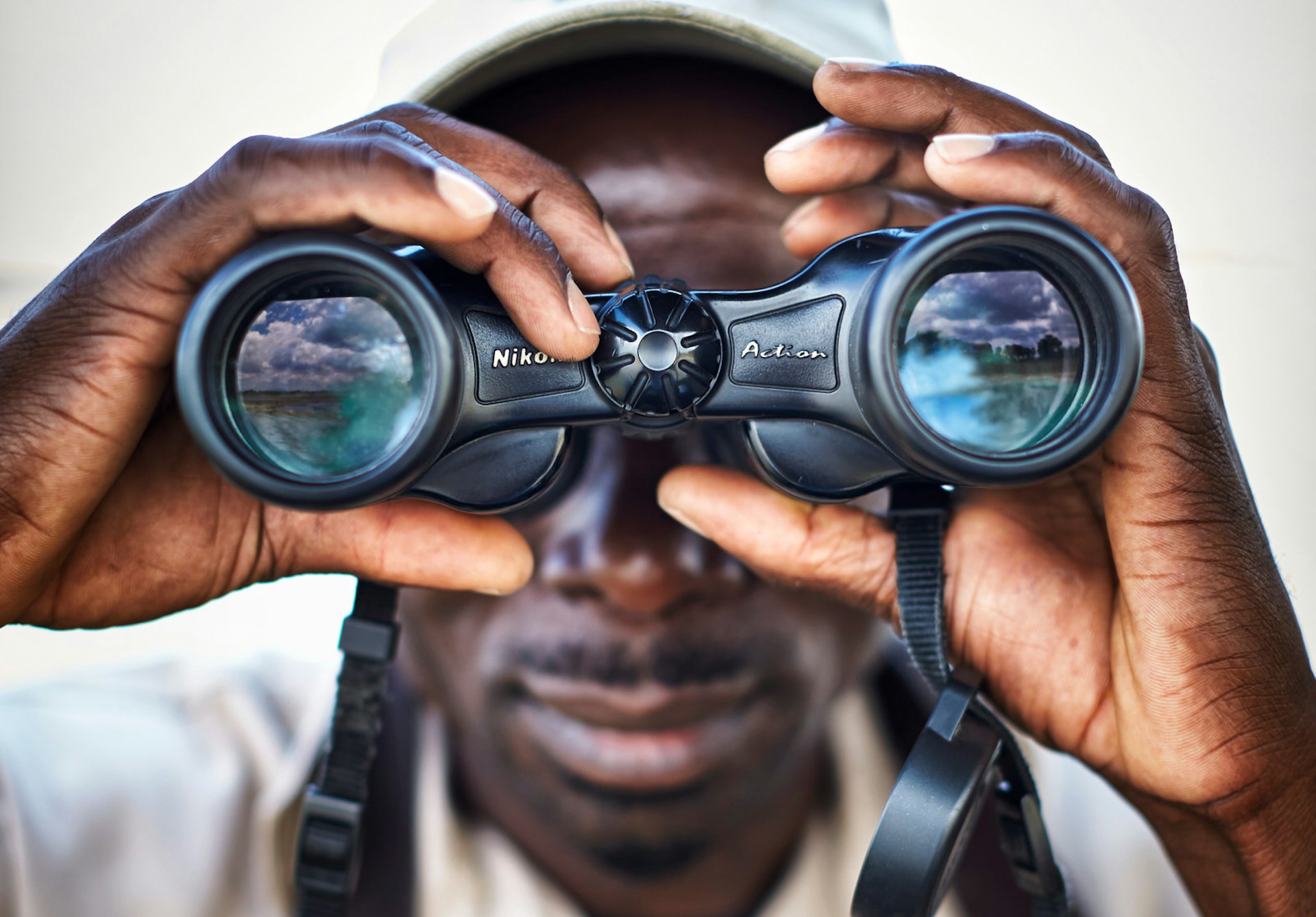 A close up of a guide at Liwonde National Park looking through binoculars