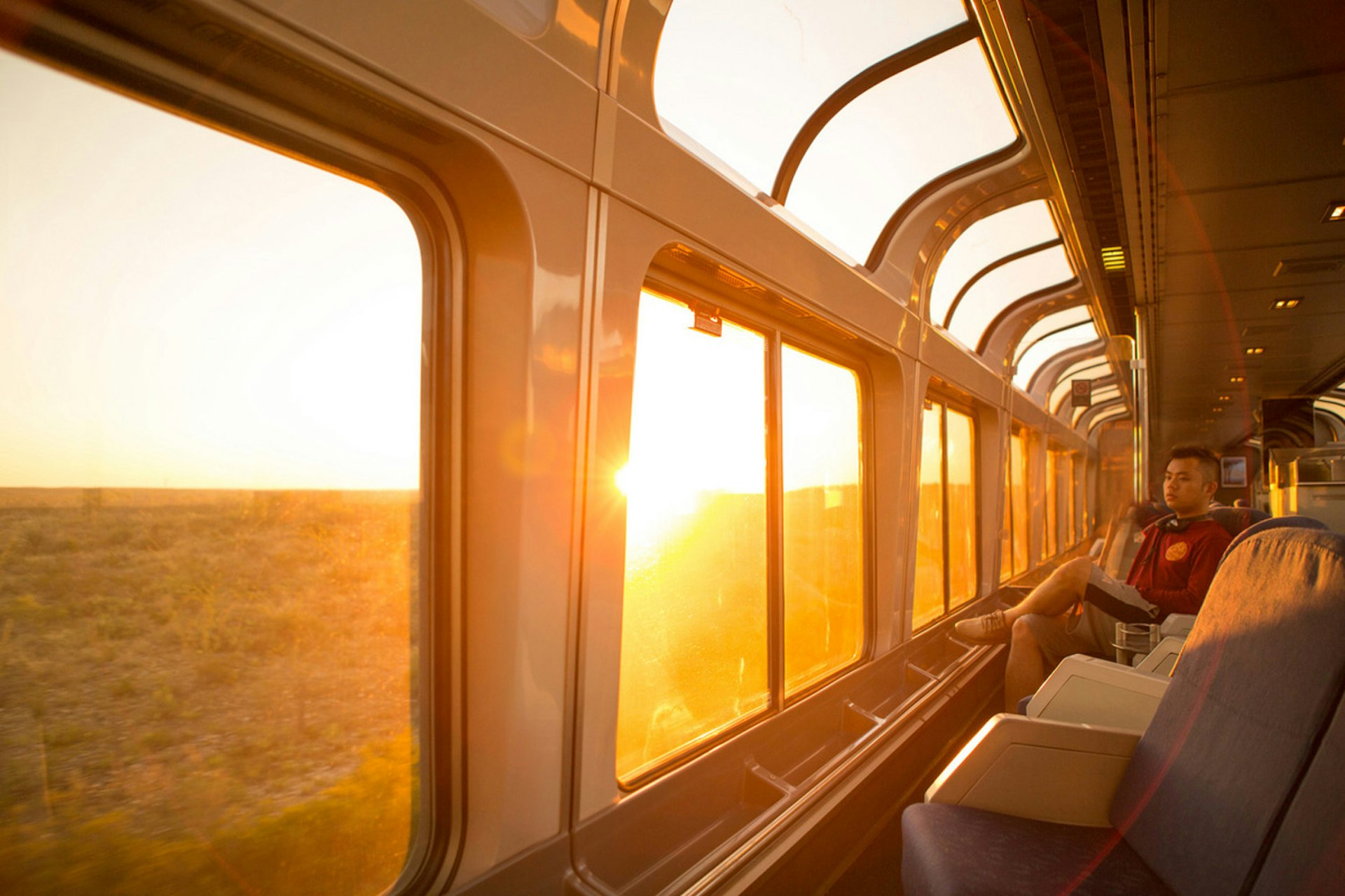 A young man watches the sun rise over Texas on the Amtrack train traveling from San Antonio to Alpine.