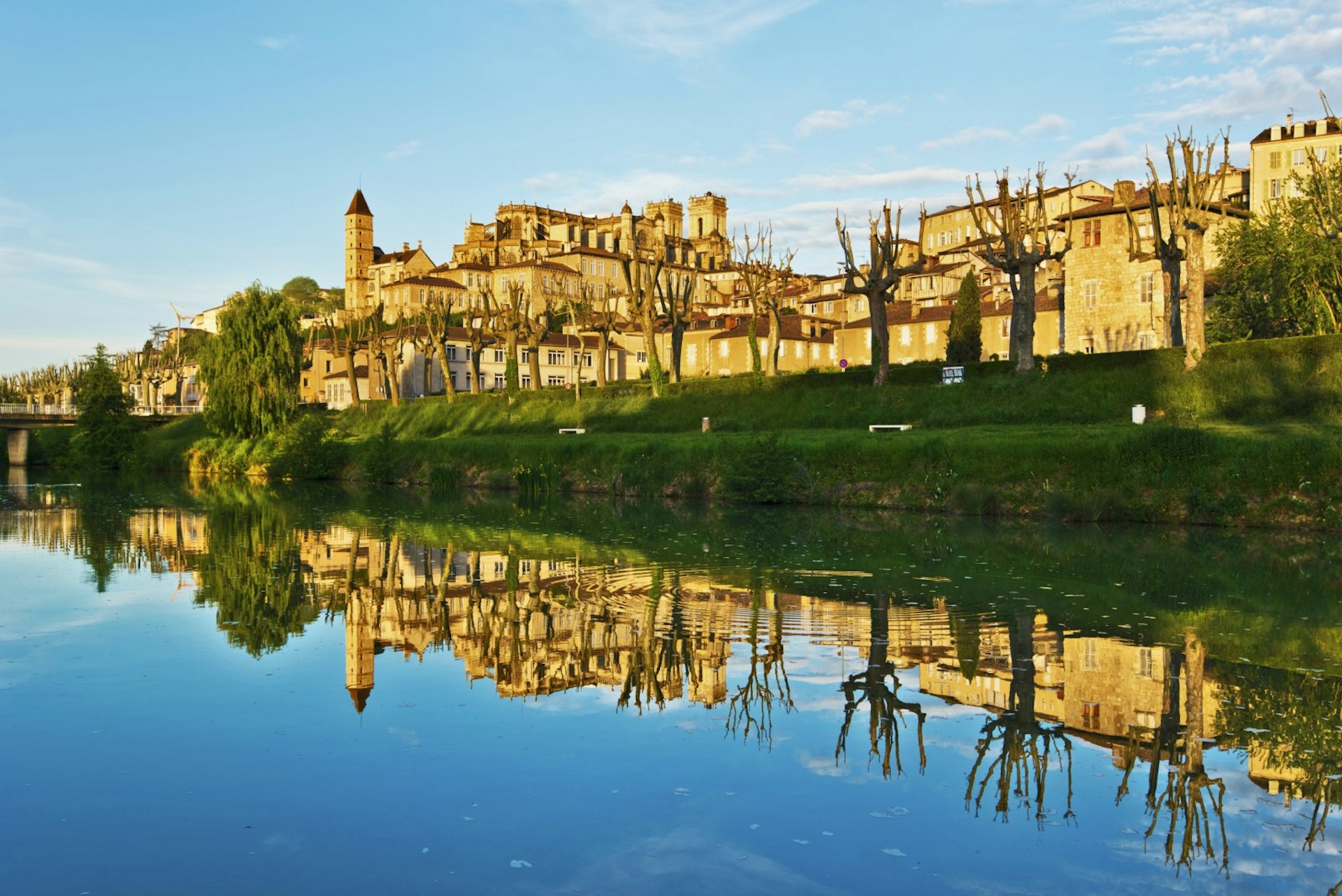 The historic city of Auch, France, shimmers in the Gers river. Image © sasha64f / Shutterstock