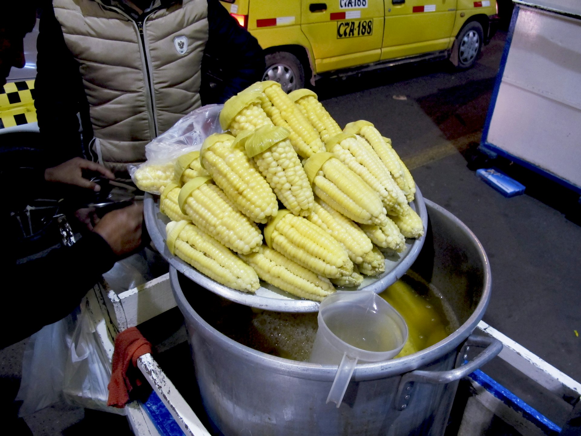 Fresh, large-kernel Peruvian corn stacked high after boiling in sweetened water © Agnes Rivera / Lonely Planet