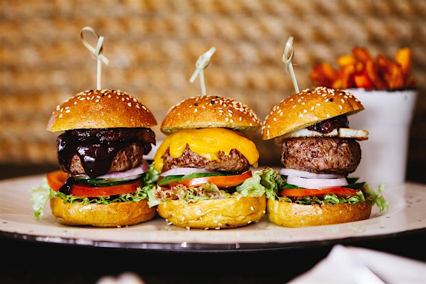 A trio of camel sliders with different toppings including date and lime jam in Dubai. Image by NikAndTam