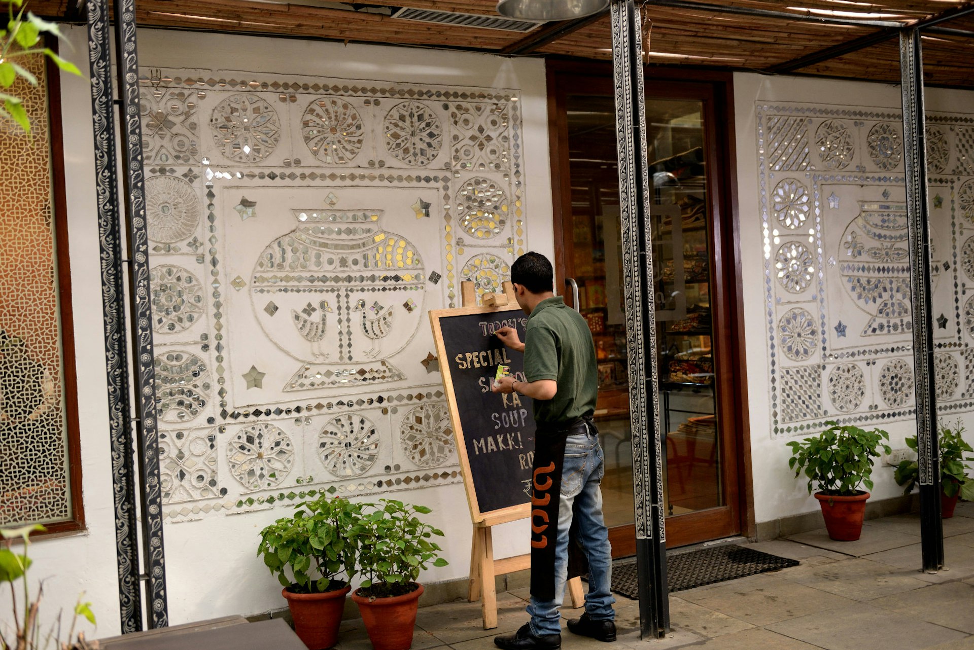 Chalking up the specials board at Cafe Lota © Mint / Contributor / Getty Images