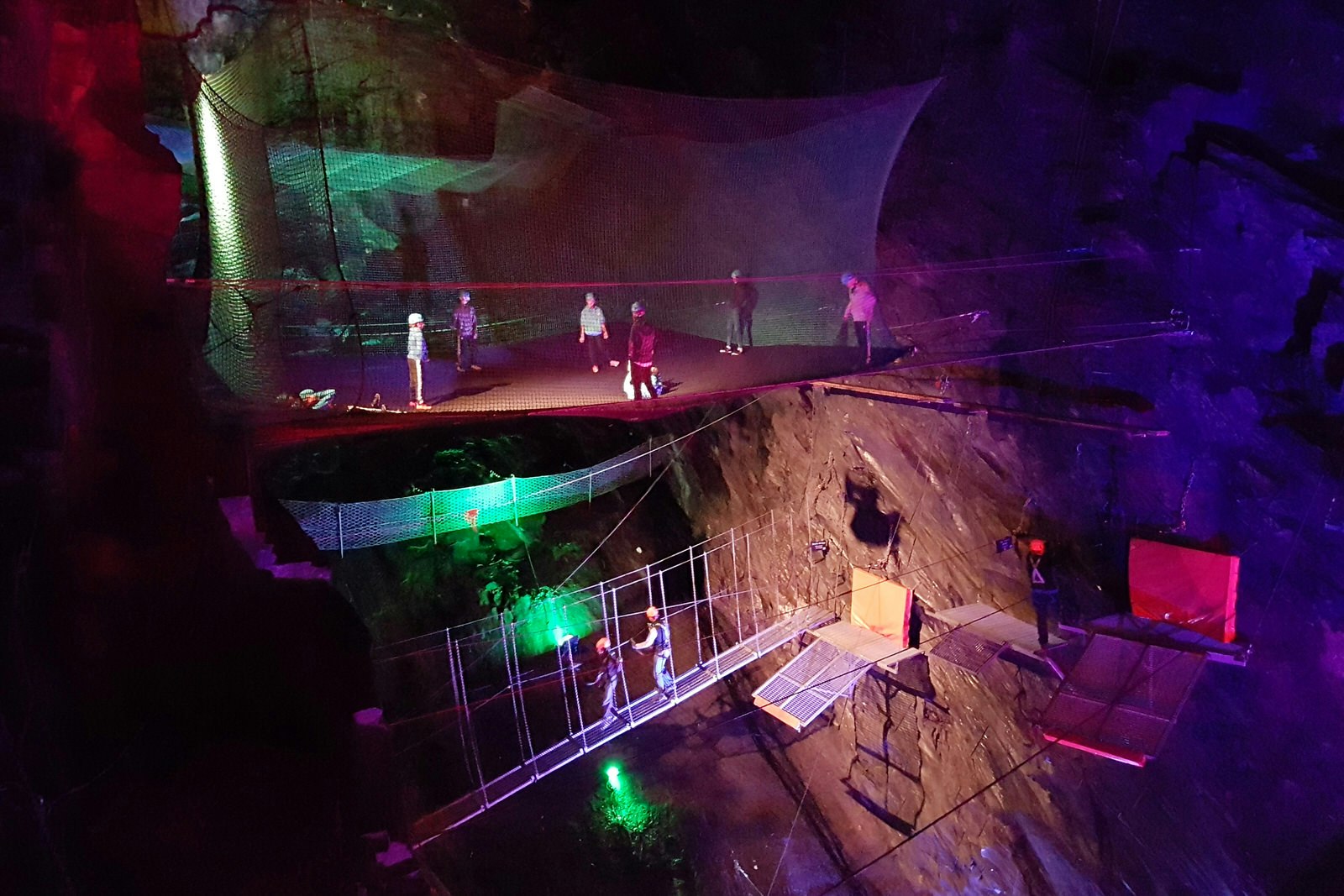 Trampolines and zip lines hang in cathedral-sized caves at Blaenau Ffestiniog © James Smart / Lonely Planet