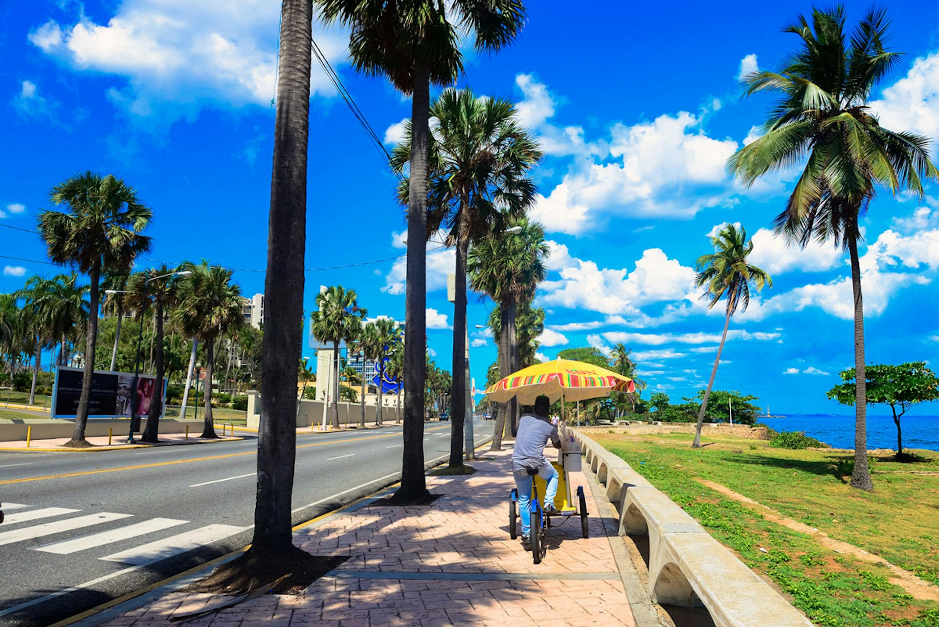 An ice cream vendor cycles down the malecón © Lebawit Girma / Lonely Planet